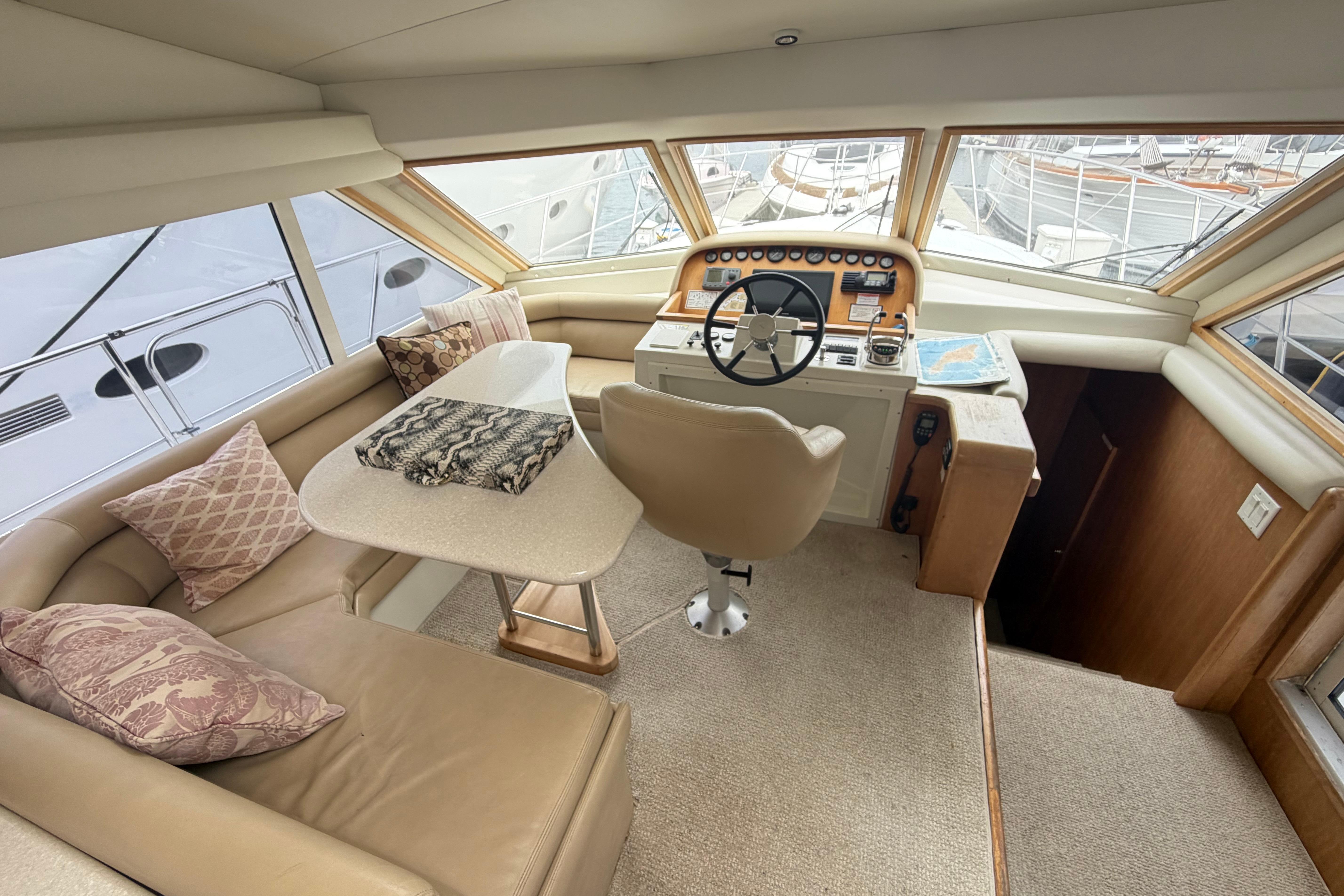 Luxurious 2005 Navigator 53 PILOT HOUSE yacht interior with helm and seating area.
