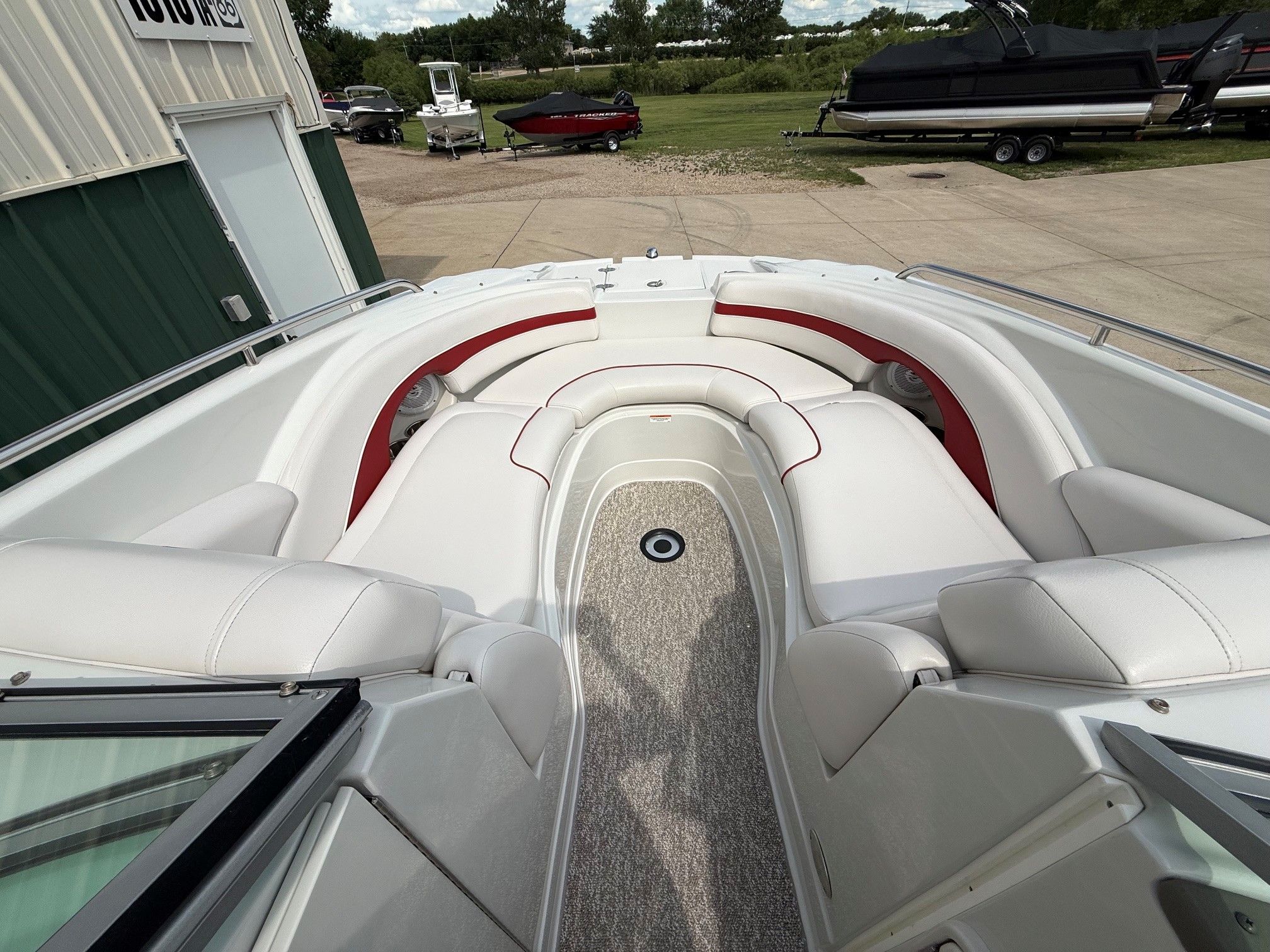 The image shows the cockpit of a 2012 Crownline 252 EX boat with white seating.