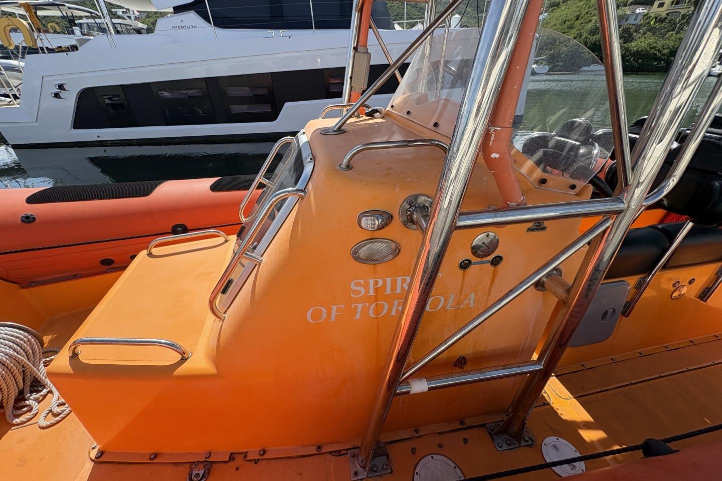 Orange Parker 1000 Baltic boat, 2018 model, docked near a white yacht.