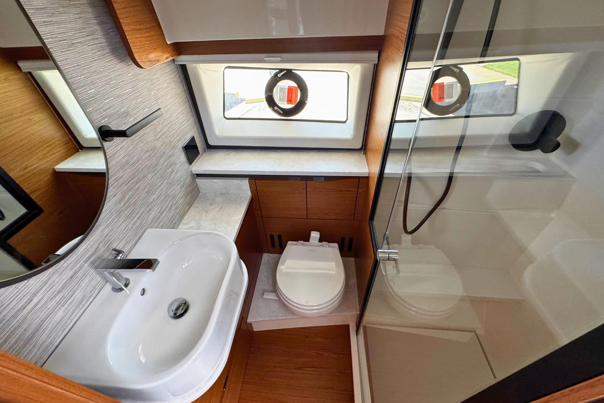Modern bathroom interior of 2027 Tiara Yachts 39 LE with sink, toilet, and shower.