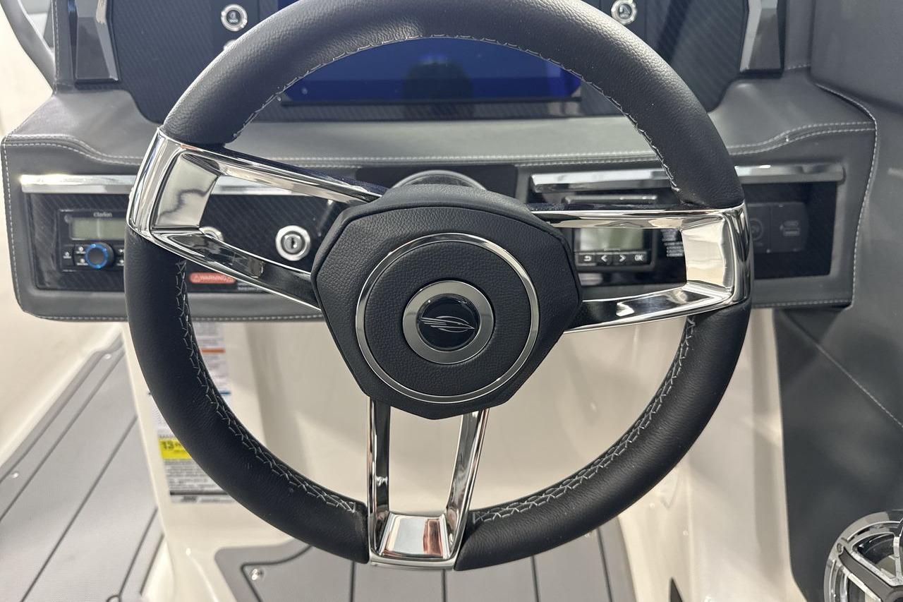 The image shows the steering wheel of a Chaparral SSX 4 boat.