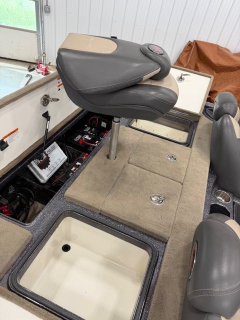 Interior of 2011 Ranger Z520 Comanche boat with seat and storage compartments.