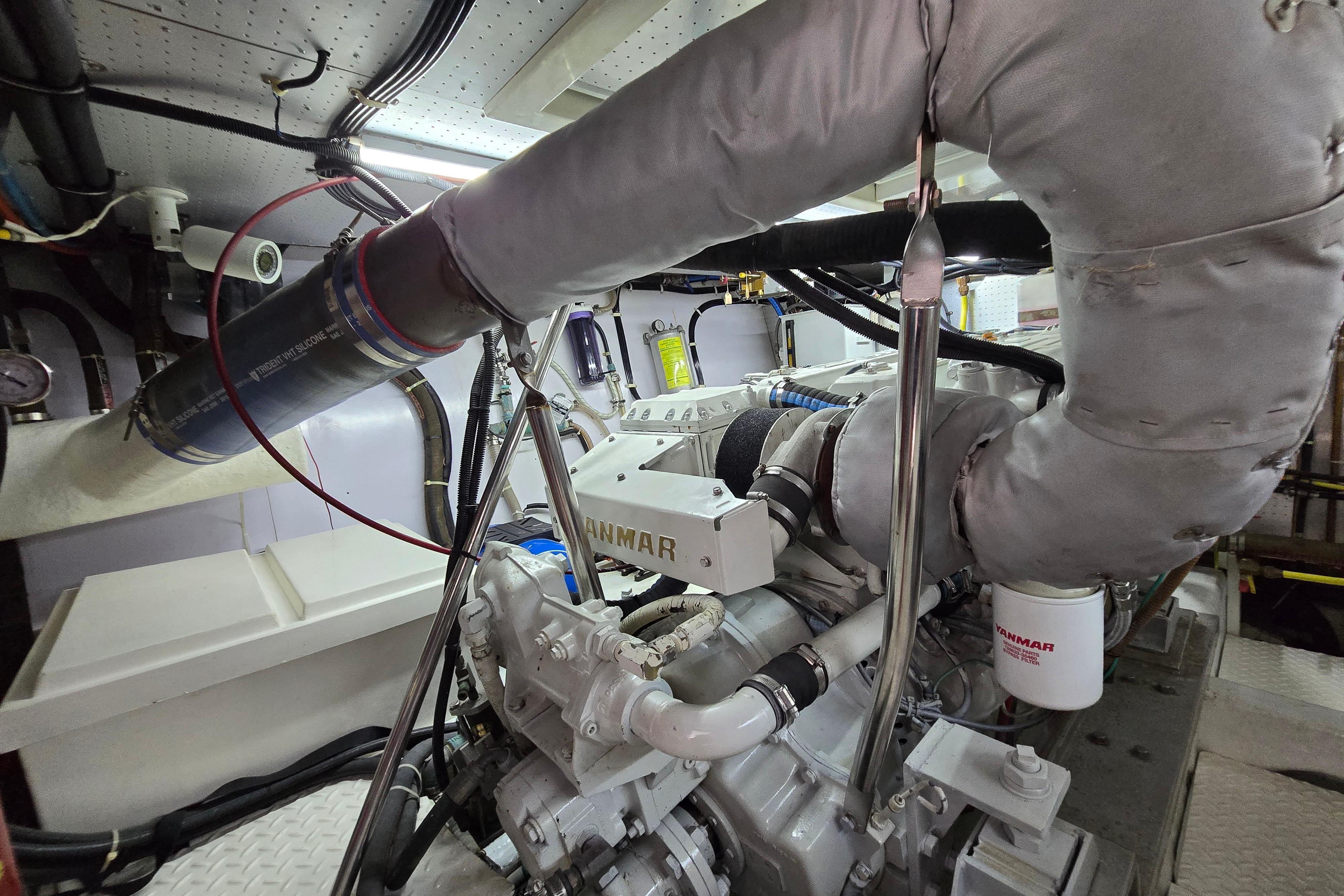 Engine room of a 2004 Grand Harbour 58 yacht, featuring a Yanmar engine.
