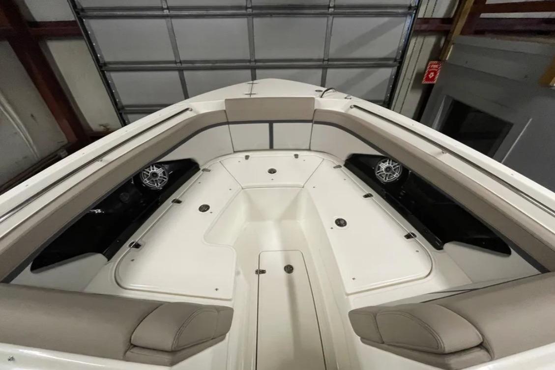 2025 Boston Whaler 330 Vantage boat interior with cushioned seating and speakers.