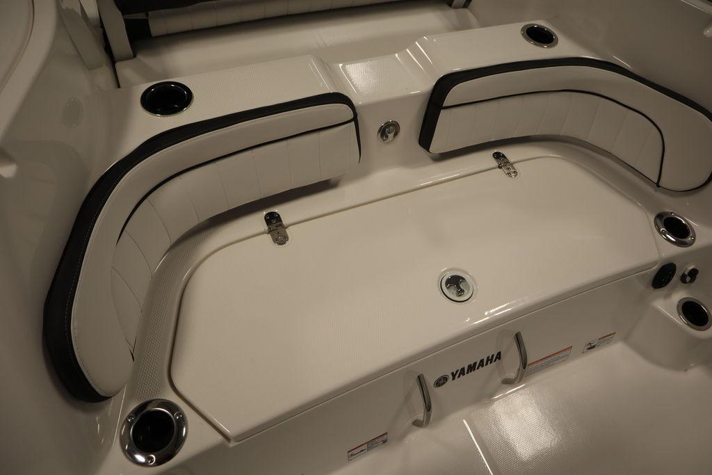 2026 Yamaha Boats 255 FSH Sport E interior seating with cup holders and storage.