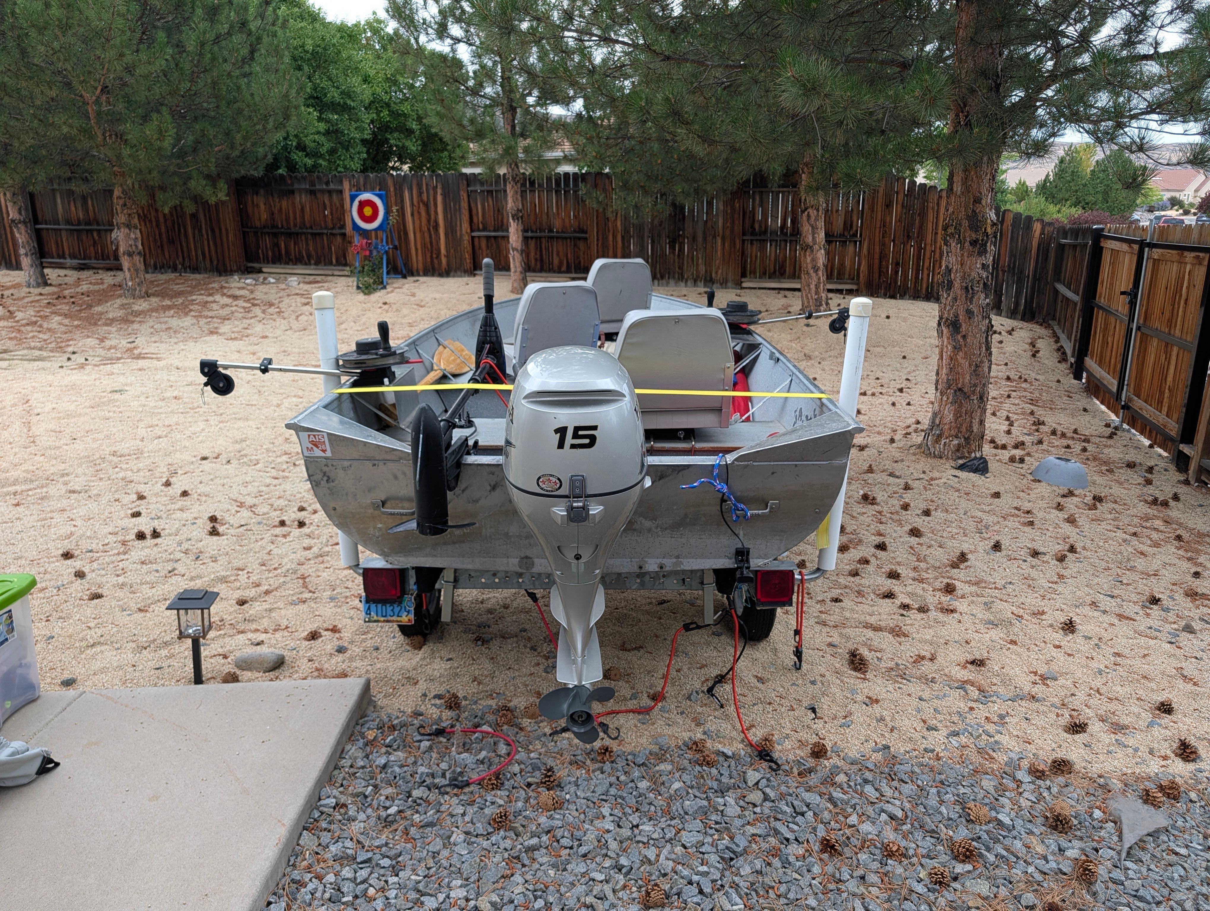 A 2004 Gregor Jon boat on a trailer in a backyard setting.