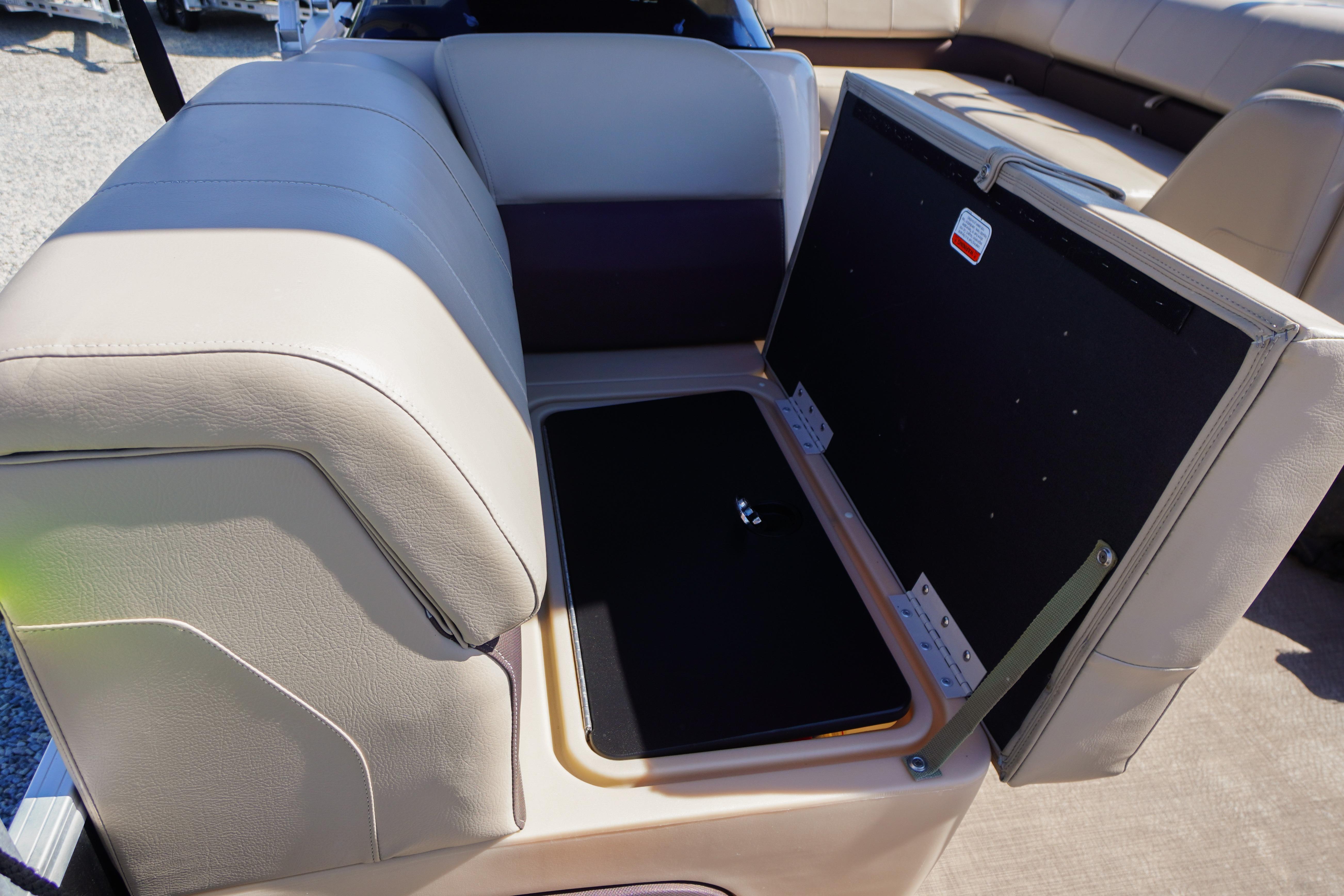 Open storage compartment on 2019 SUNTRACKER Fishin' Barge 22 DLX boat seat.