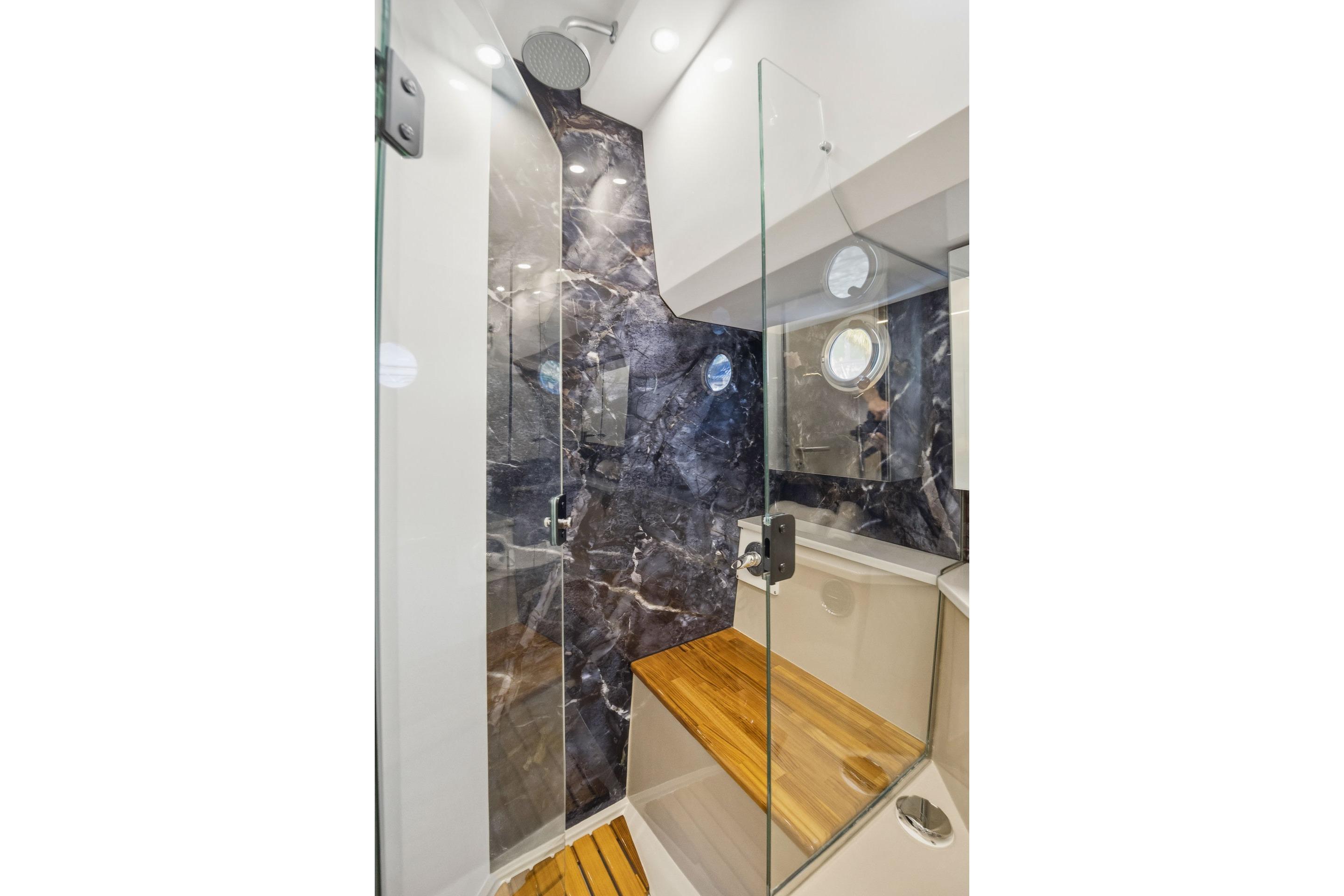 Luxurious Hanover 447 yacht bathroom with glass shower and elegant marble accents, 2026 model.