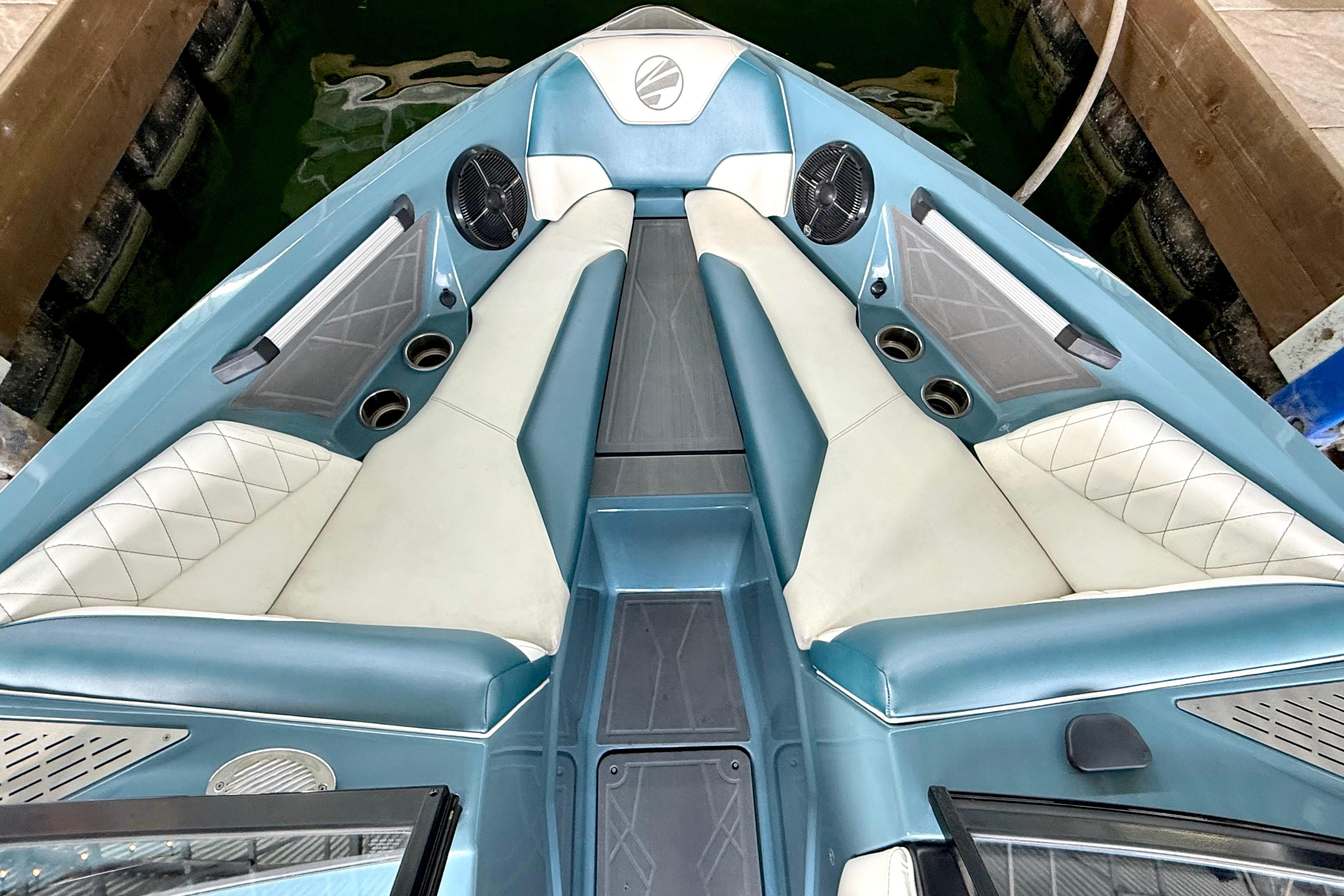 2021 Tige Z3 boat interior with blue and white seating, cup holders, and speakers.