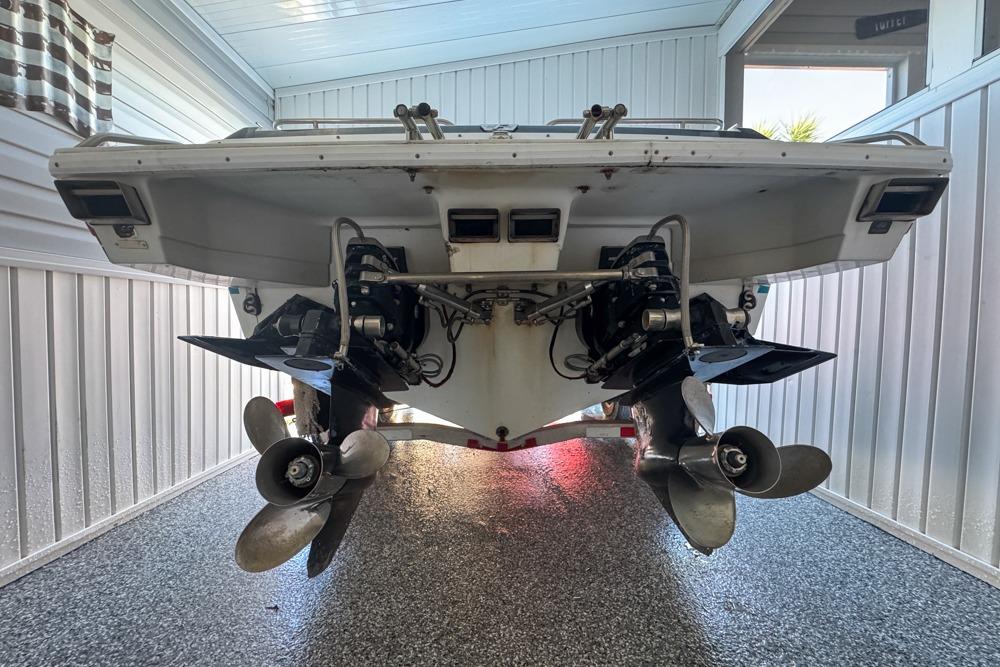1989 Formula 292 SR-1 boat stern view with dual propellers in a garage.