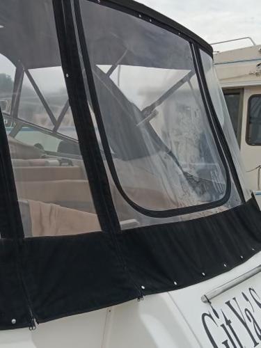 2004 Chaparral Signature 350 boat with black canvas enclosure.