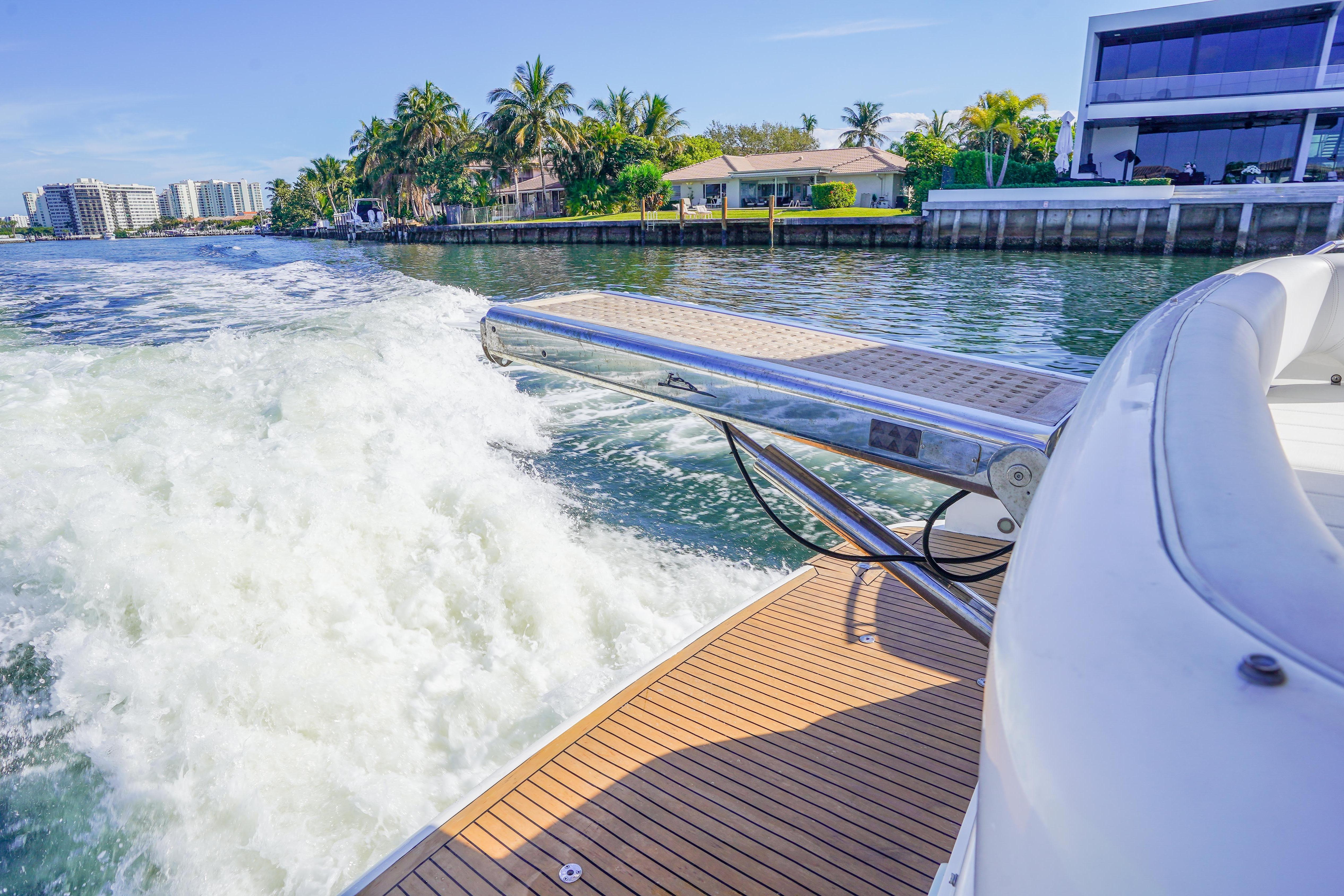 Fairline 48 Phantom yacht cruising near waterfront homes, 2009 model.