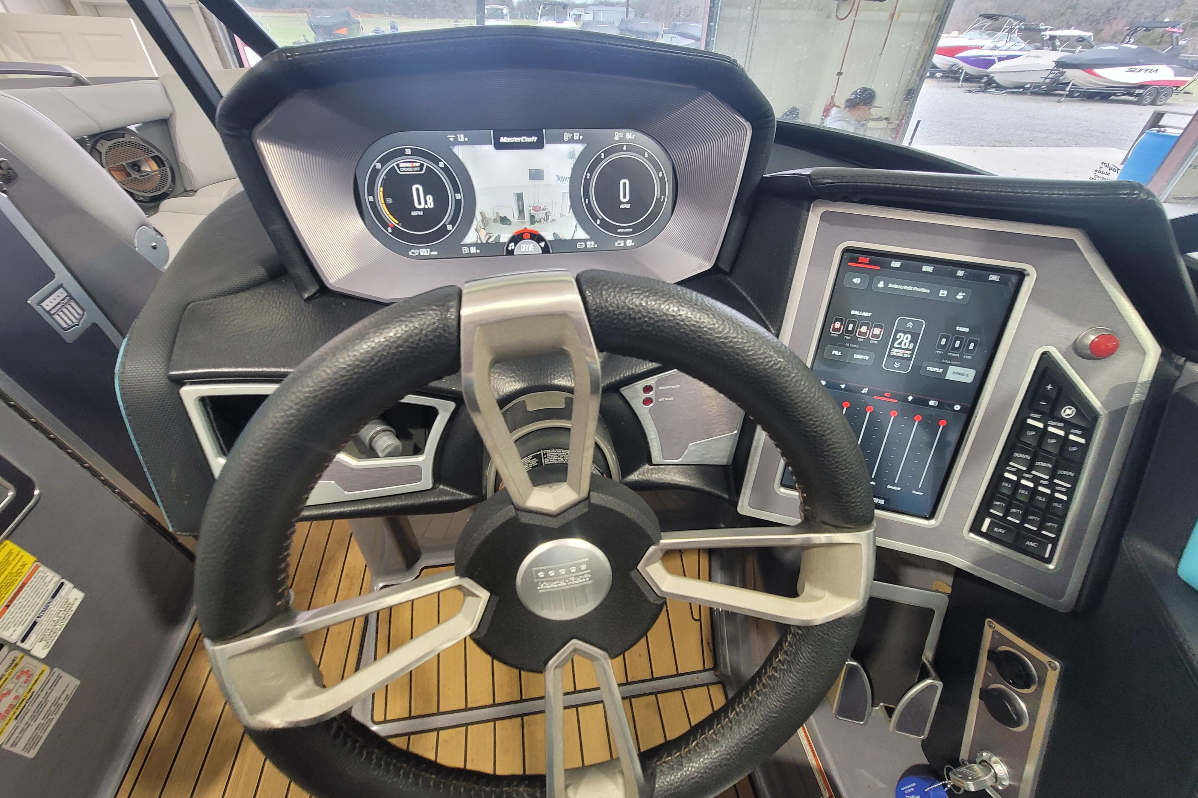 2022 MasterCraft X22 boat dashboard with steering wheel and digital controls.
