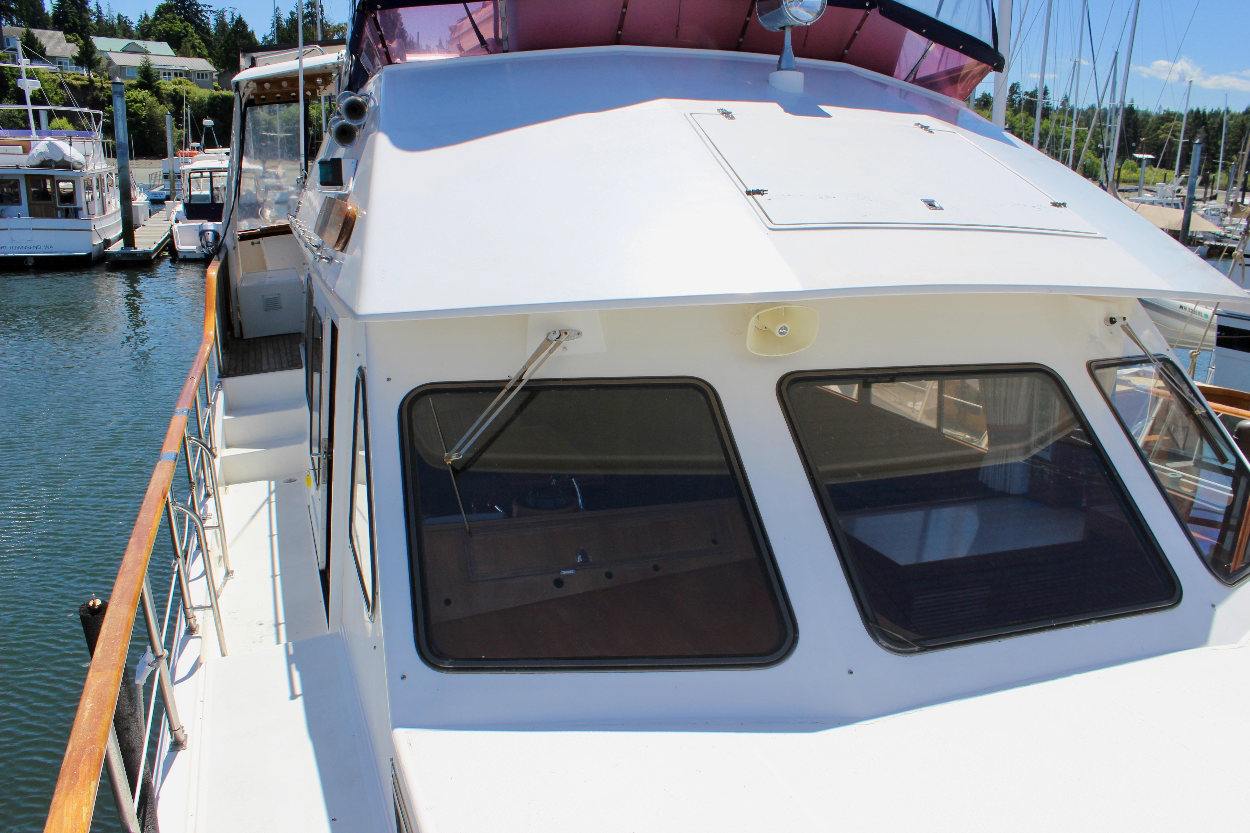 1986 Kha Shing Spindrift 46 yacht docked at marina, showcasing sleek design and spacious deck.