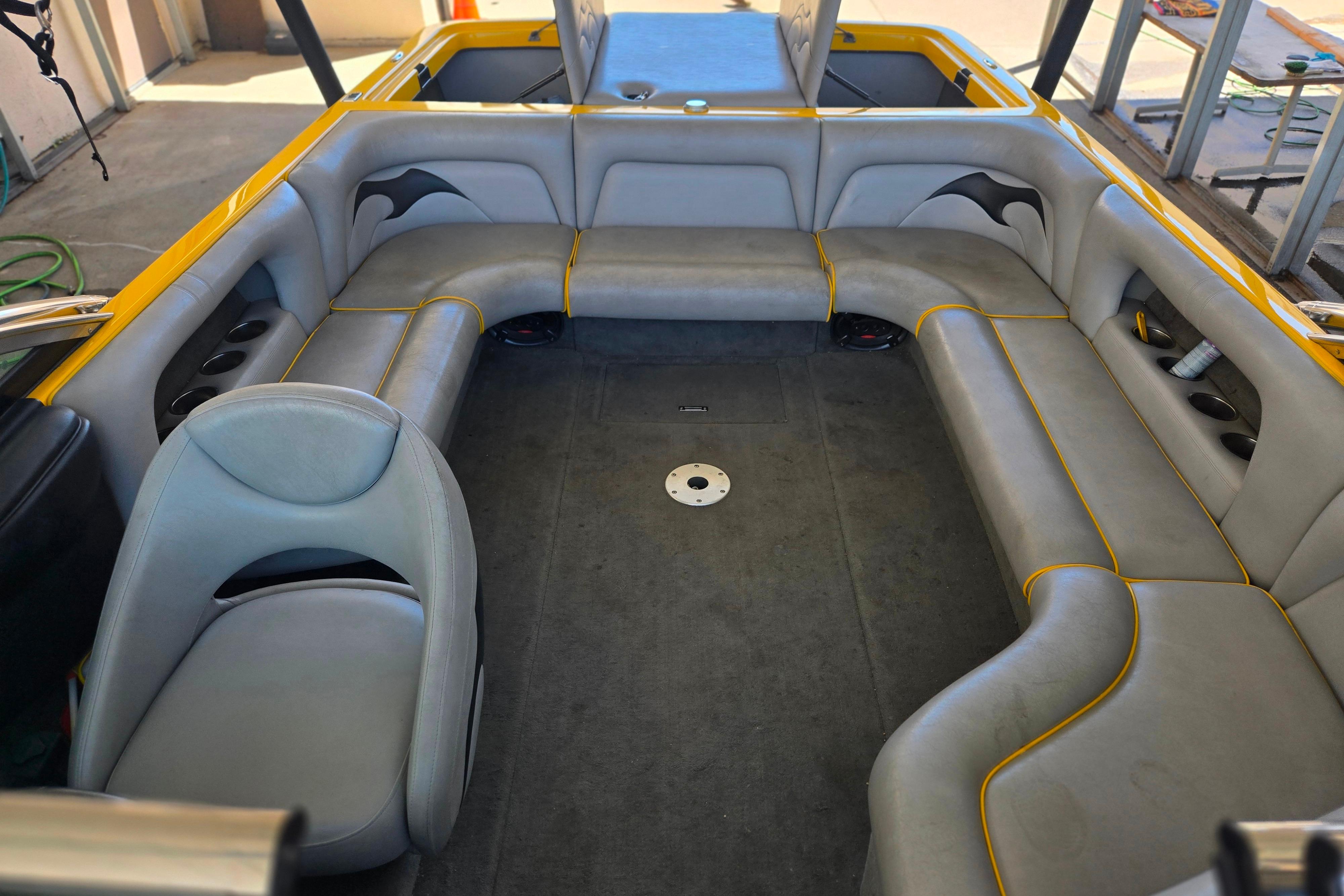 Interior of a 2007 Calabria CAL AIR PRO V boat with gray seating and yellow accents.