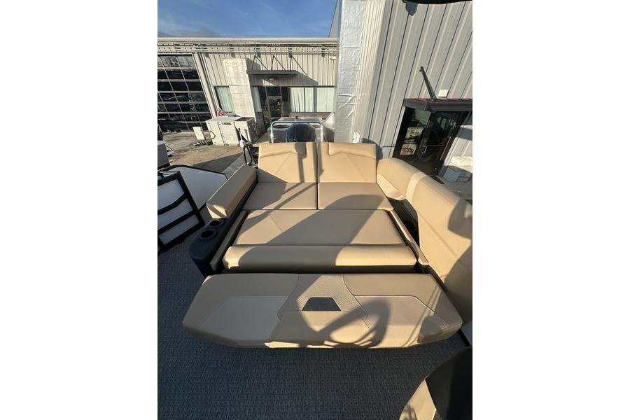 Luxurious seating on 2026 Evotti 523CS boat, featuring beige upholstery and cup holders.
