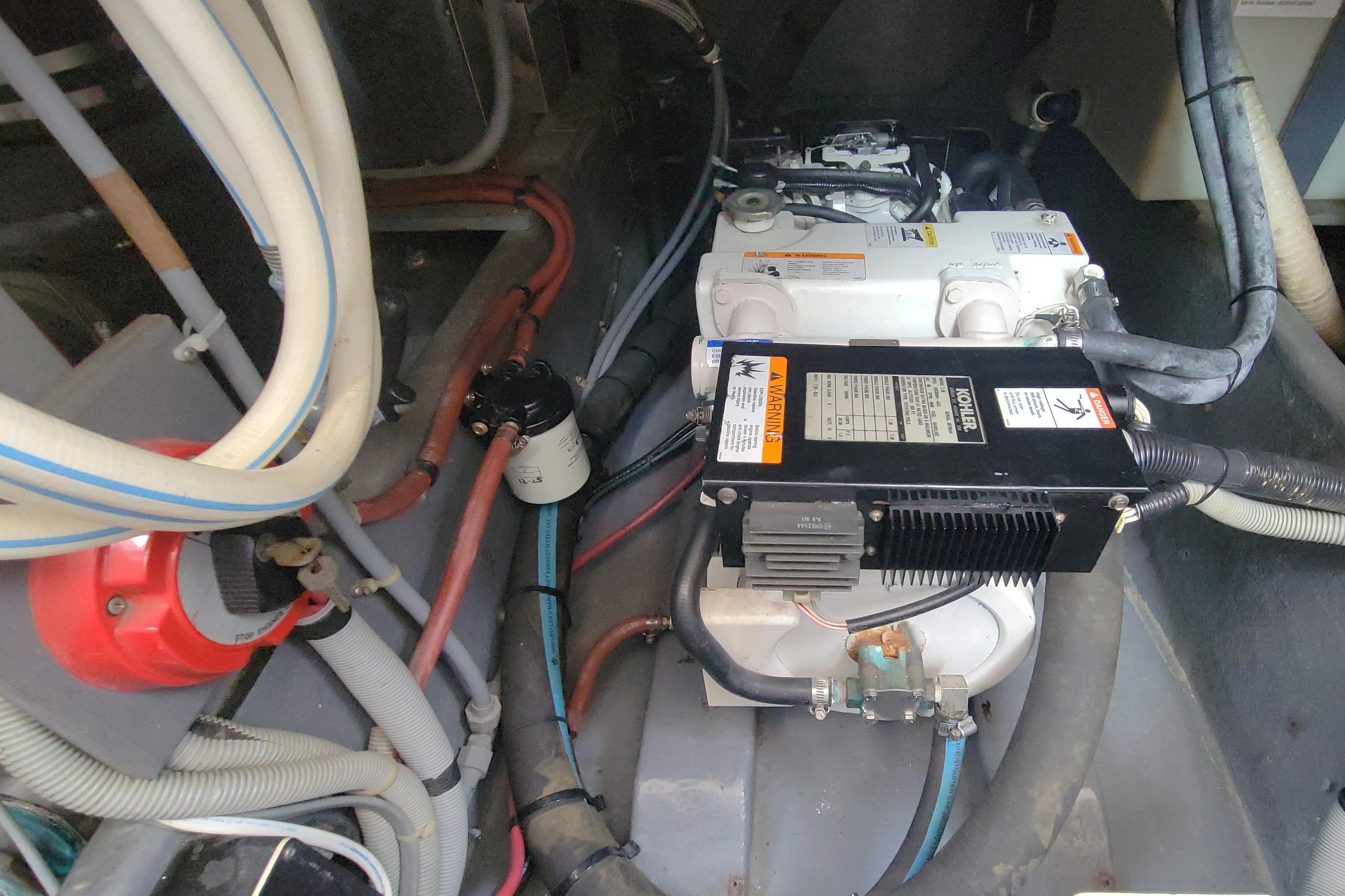 Engine compartment of a 1987 Sea Ray 390 Express with visible Kohler 7.4 generator.
