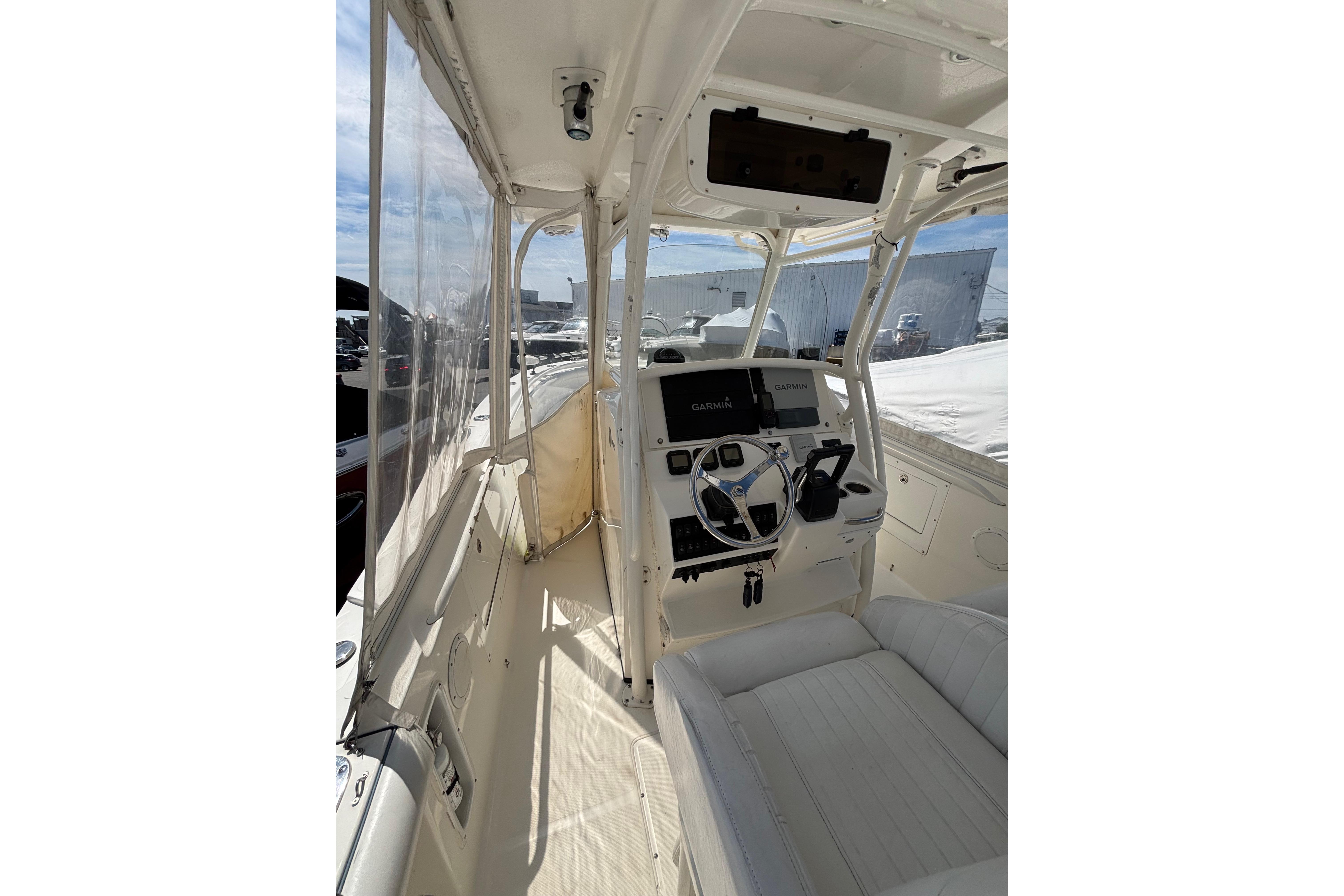 Interior view of a 2006 Edgewater 318CC boat, featuring a modern helm and seating.