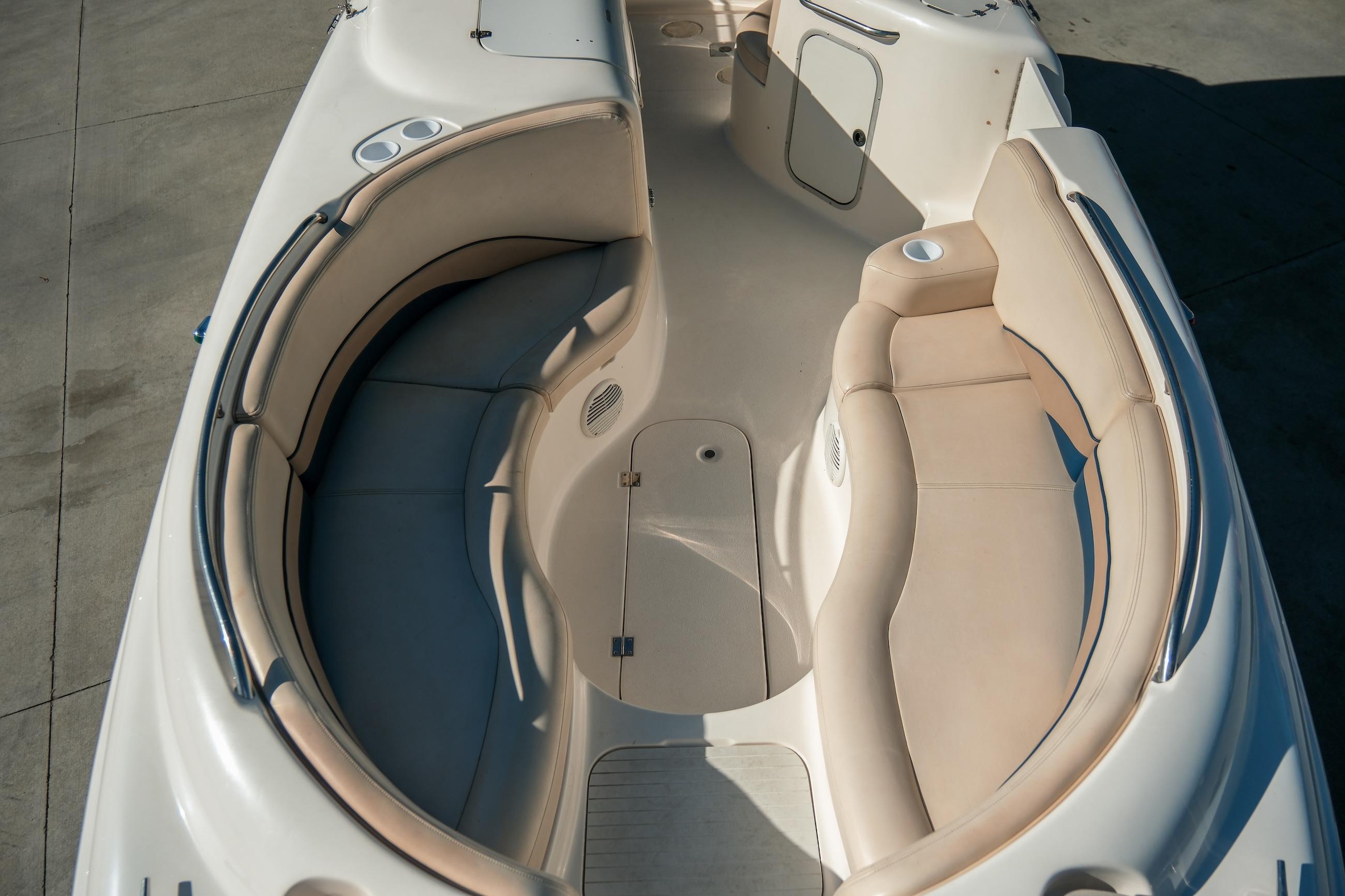 1998 Chaparral 232 Sunesta boat interior with beige seating and cup holders.
