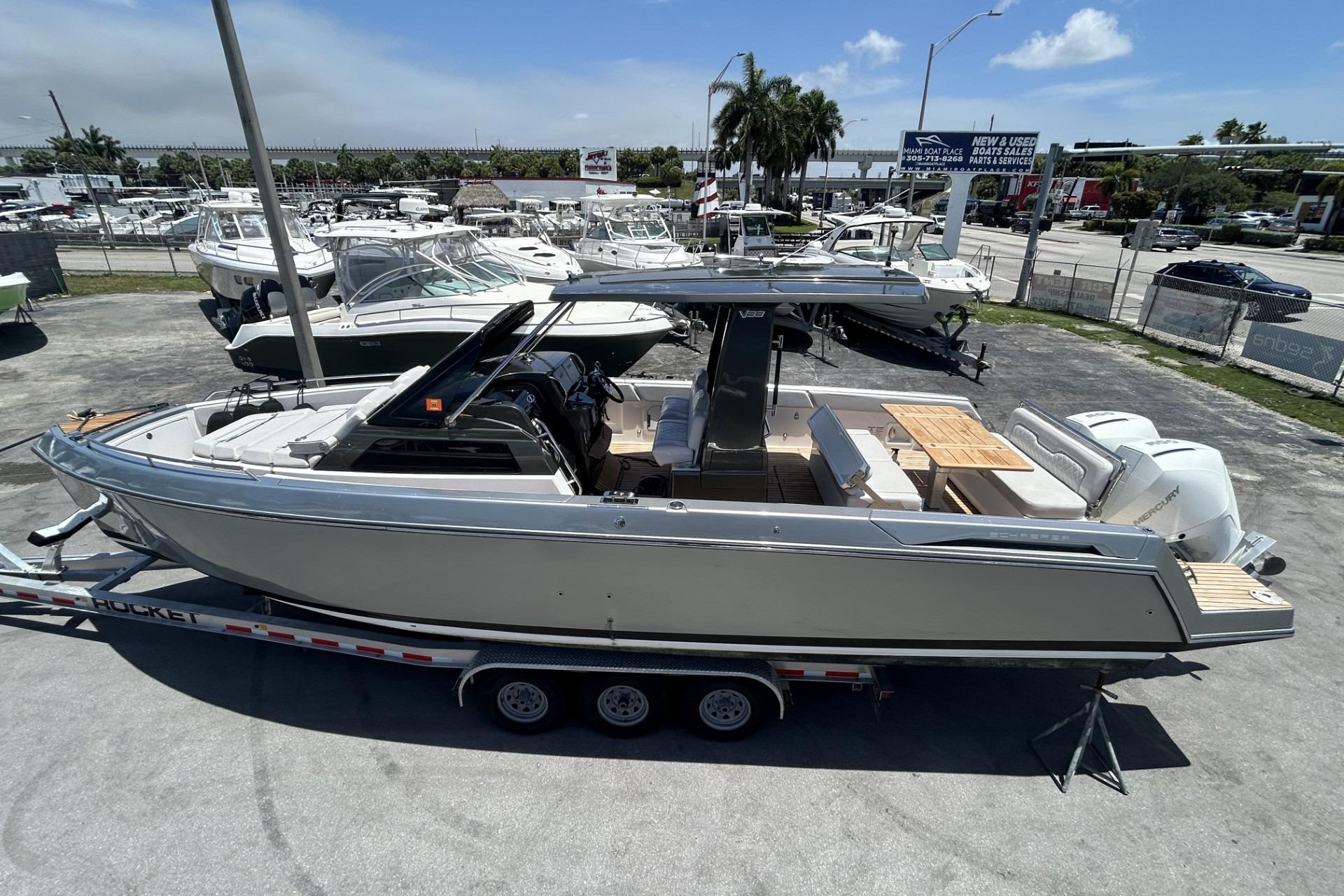 2023 Schaefer V33 boat on trailer at dealership, surrounded by other boats.