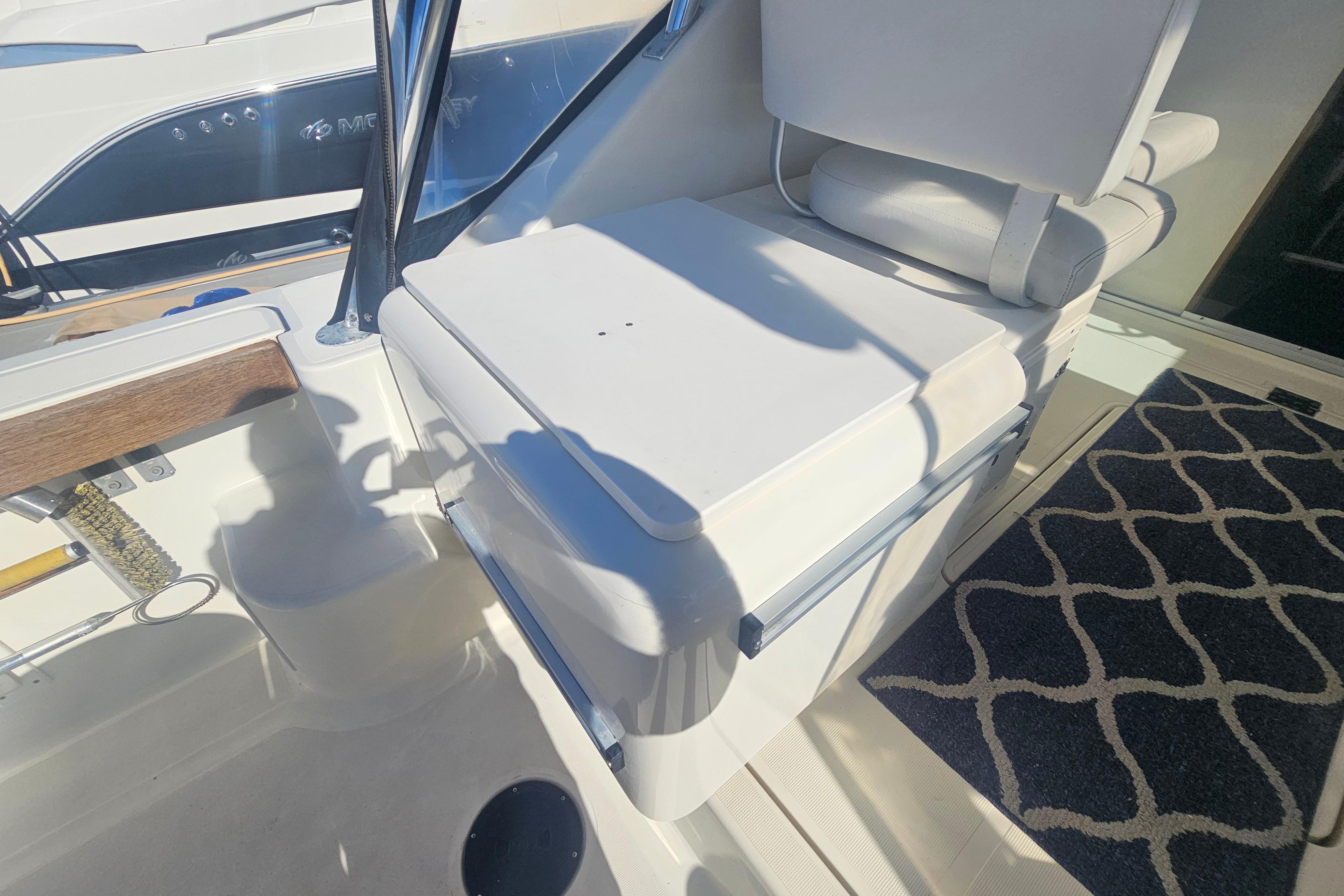 2001 Pursuit 3000 Express boat interior with white seating and patterned carpet.