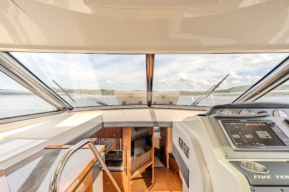 Interior view of 2016 Sea Ray Sundancer 510 yacht cockpit with panoramic windows.