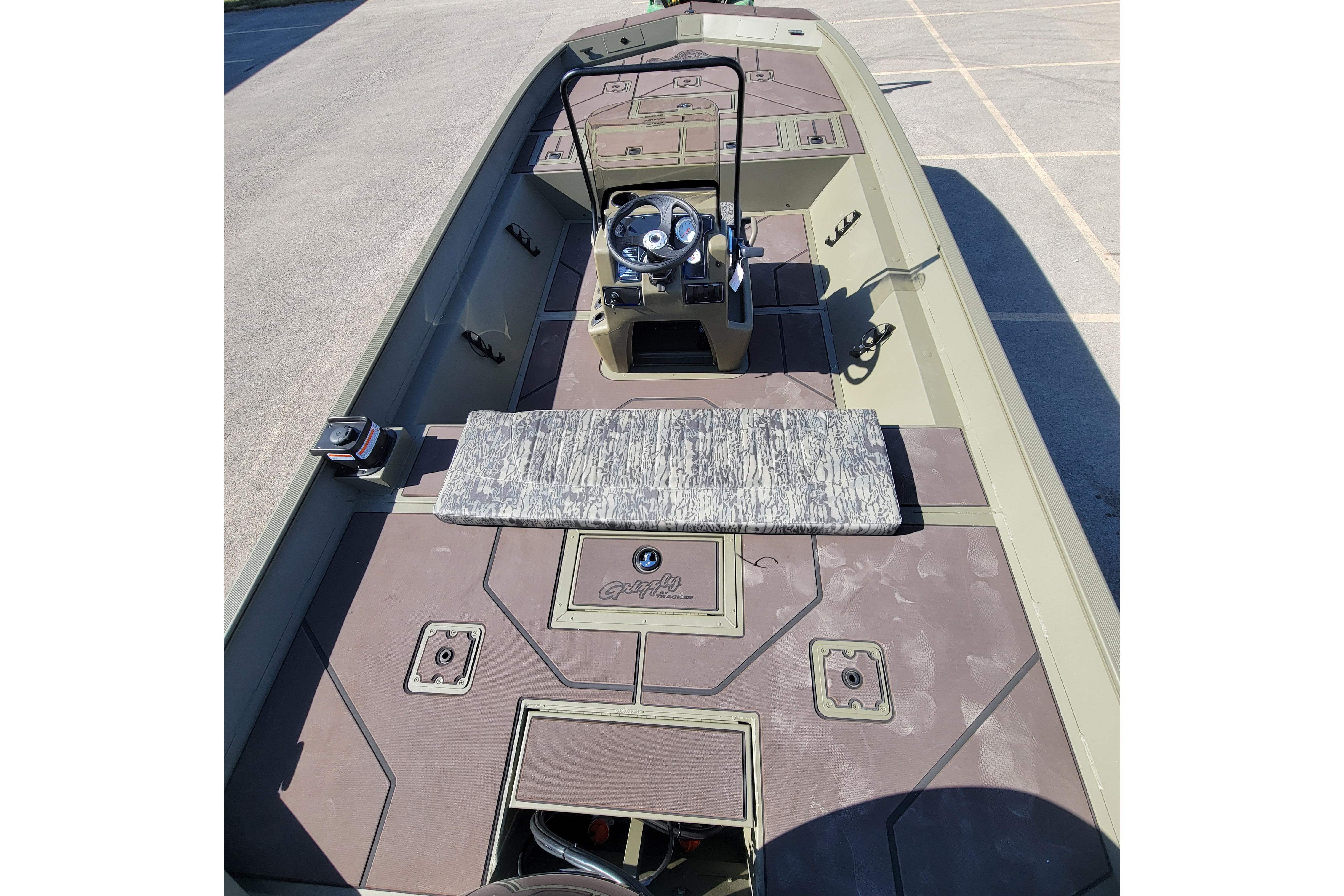 2026 Tracker Grizzly 2072 CC boat interior with steering console and storage compartments.