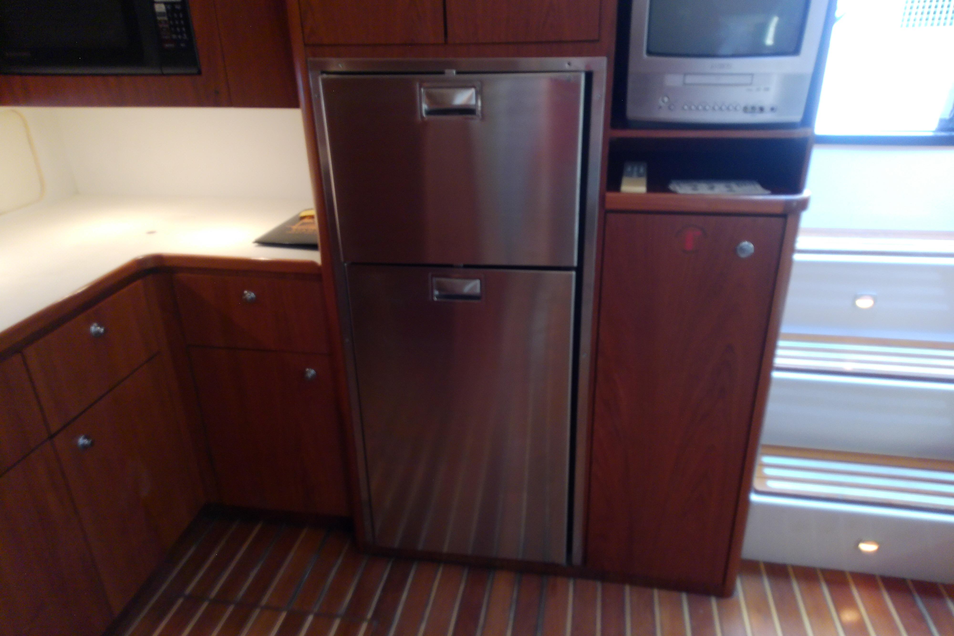Kitchen area of a 2000 Tiara Yachts 4100 Open with stainless steel appliances.