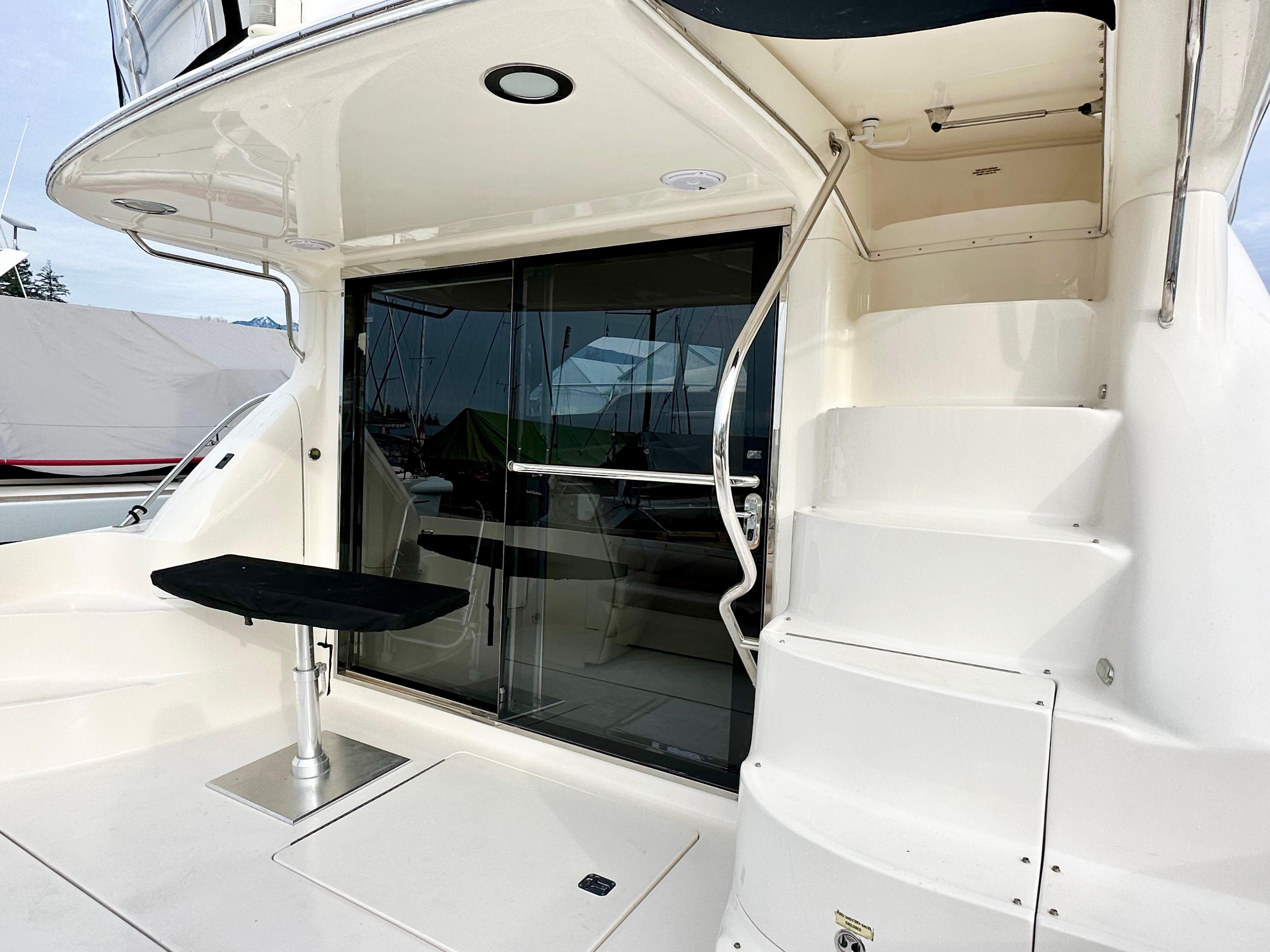 2002 Sea Ray 560 Sedan Bridge yacht with sleek exterior and elegant staircase.