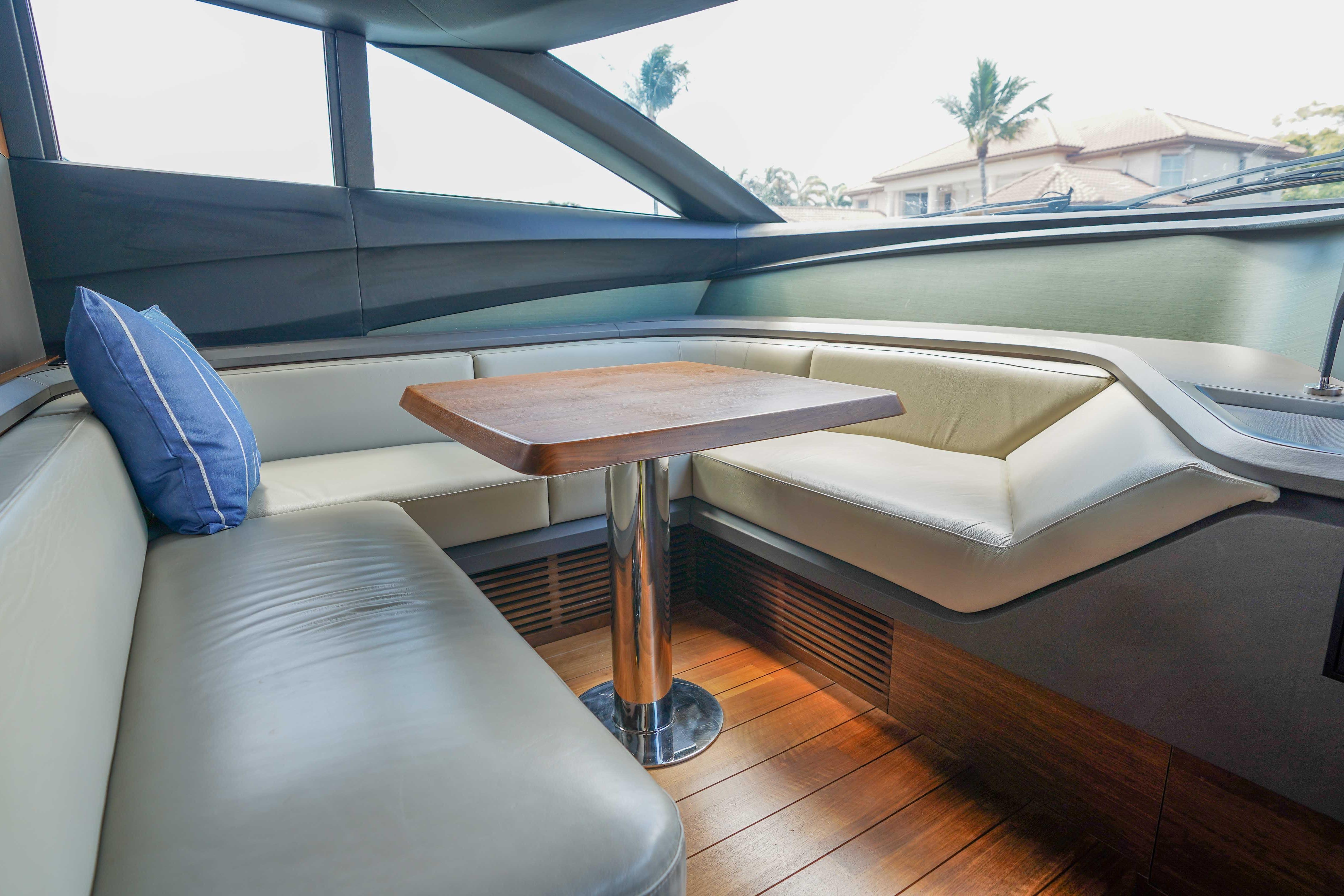 Luxurious interior of 2021 Princess Y85 yacht with elegant seating and wooden table.