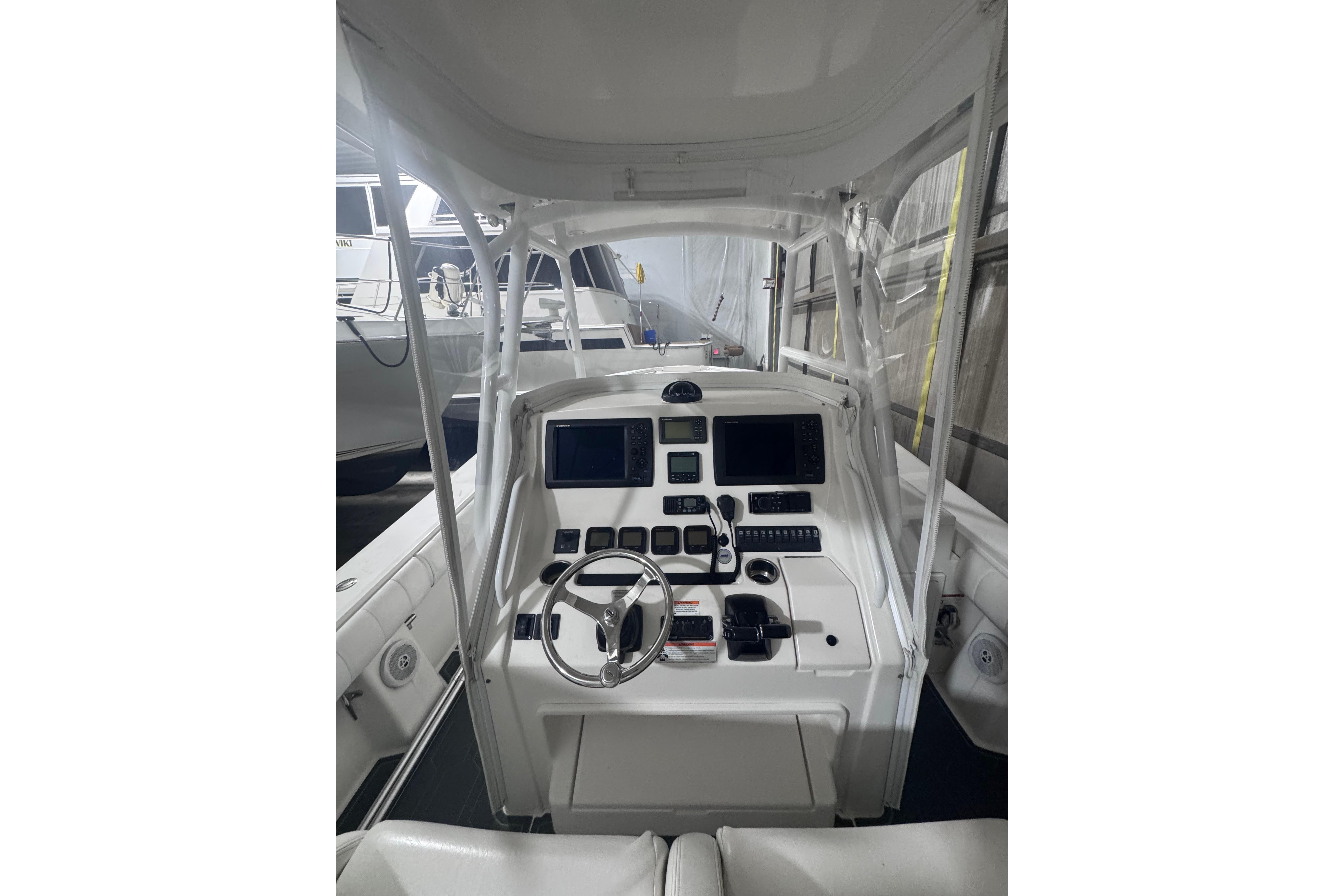 2010 Regulator 34SS boat cockpit with steering wheel and navigation controls.