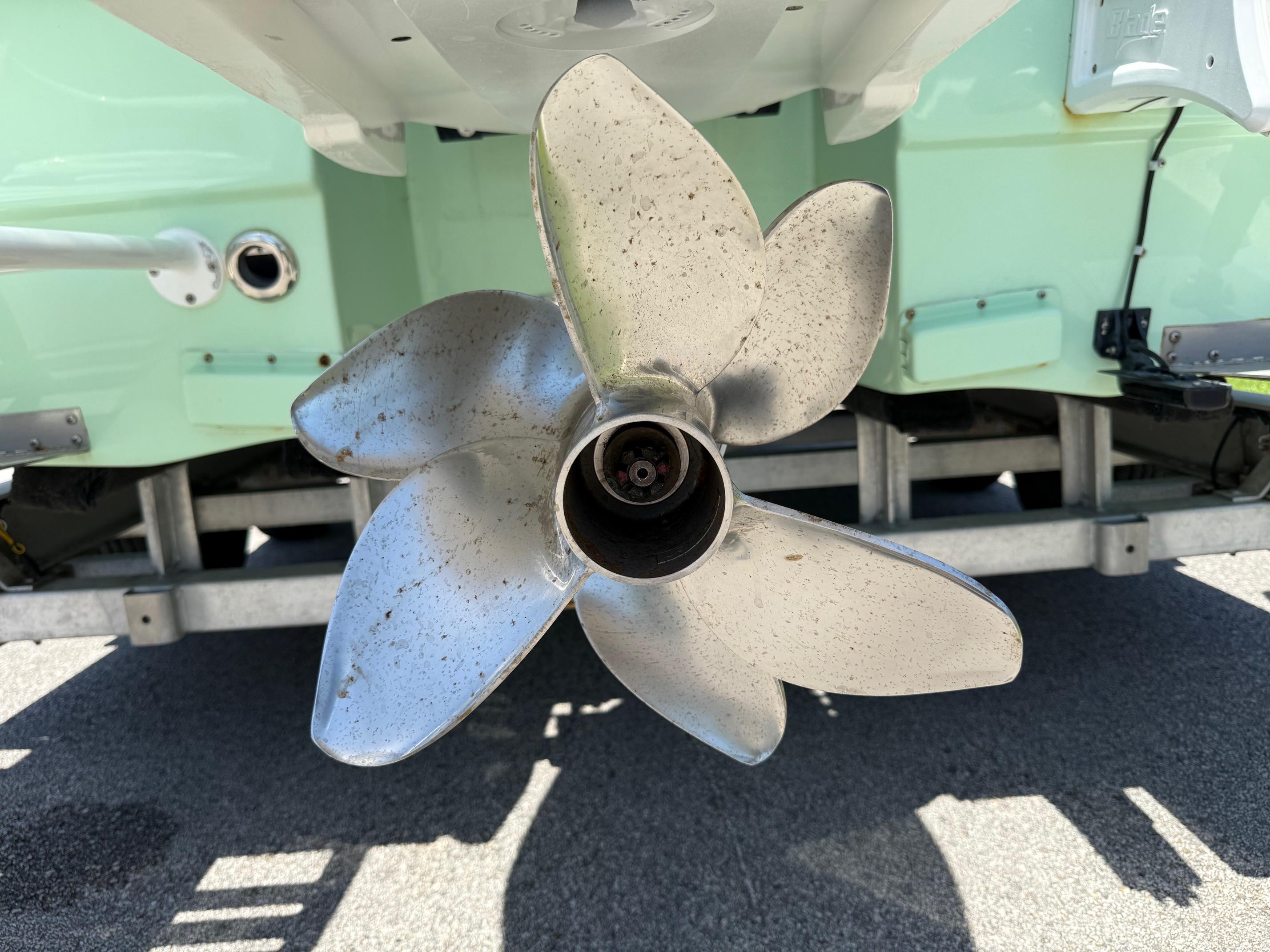Close-up of a 2023 Shallow Sport 24 Sport boat propeller on a trailer.