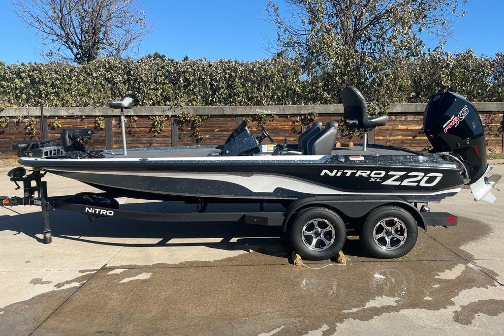 2025 Nitro Z20 XL Pro boat on trailer, parked outdoors, showcasing sleek design and powerful engine.