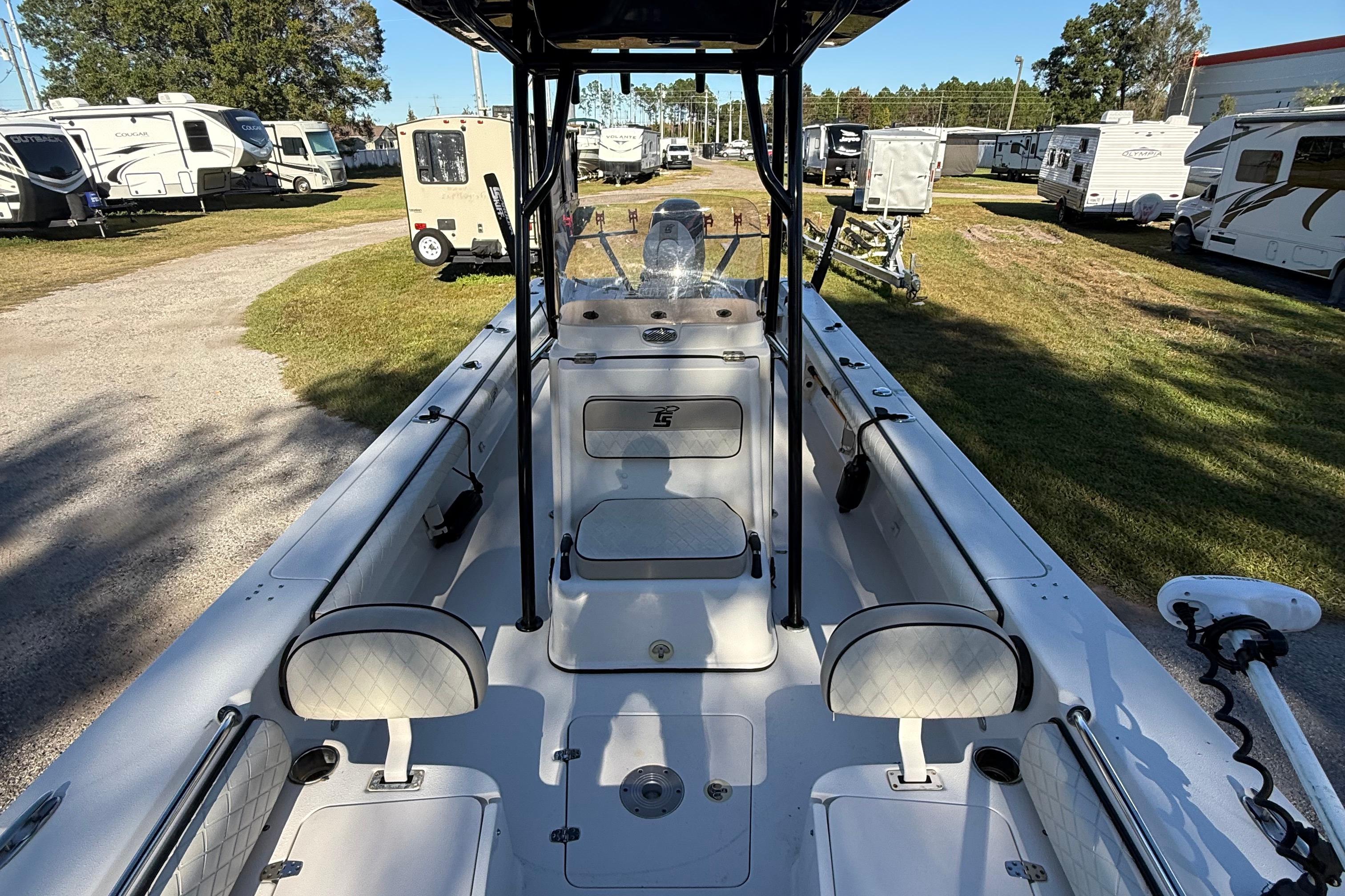 2021 Carolina Skiff 26 Ultra Elite boat interior, parked among RVs and trailers.