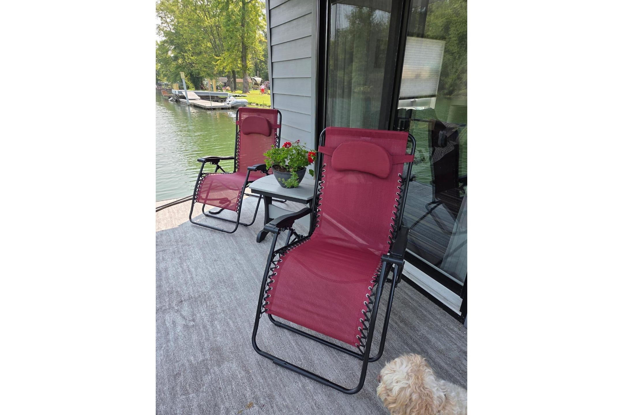 Red lounge chairs on a houseboat deck, East Coast Houseboats Freedom 40, 2021 model.
