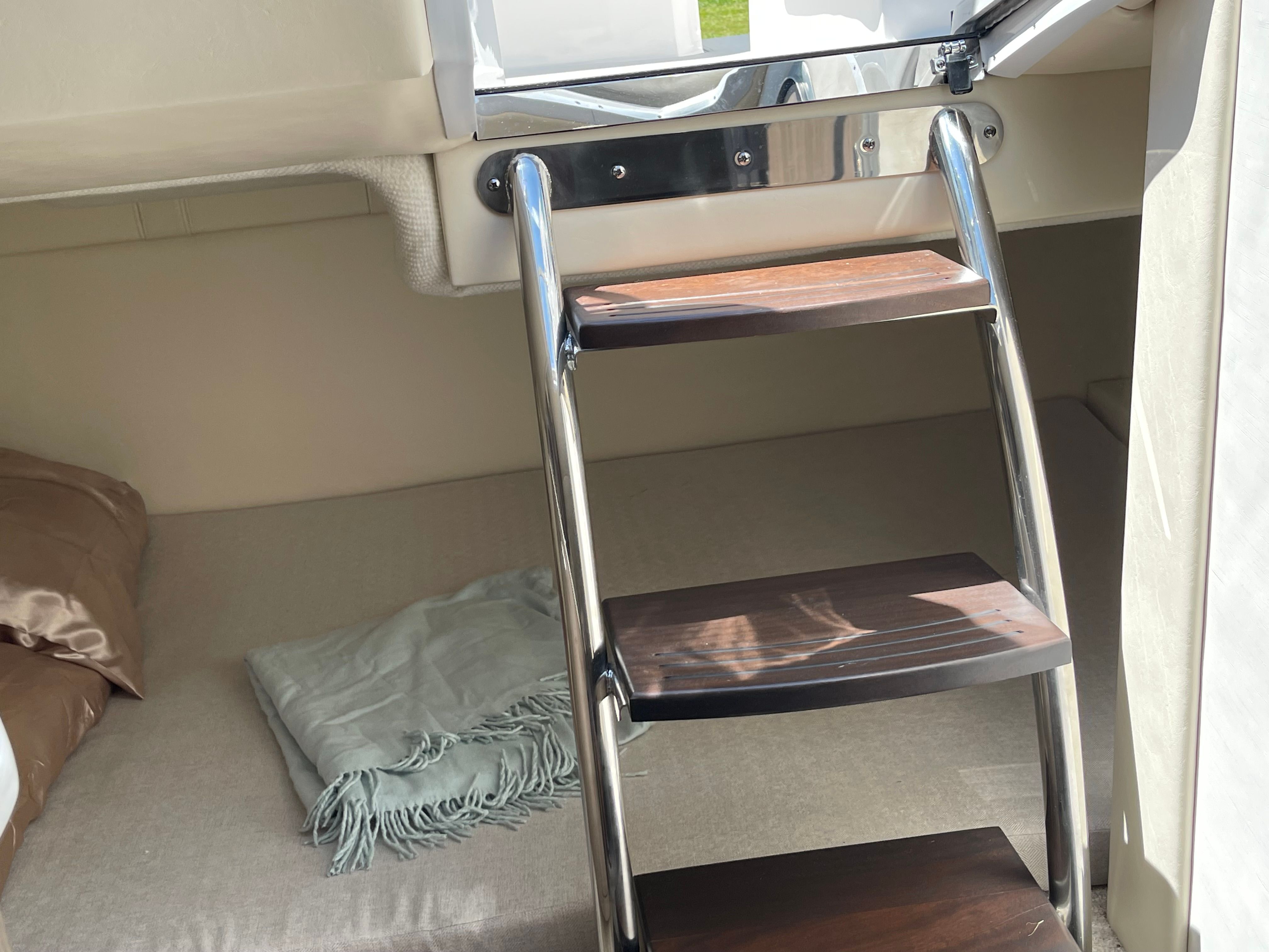 Interior of 2022 Regal 26 Express with ladder and bed.