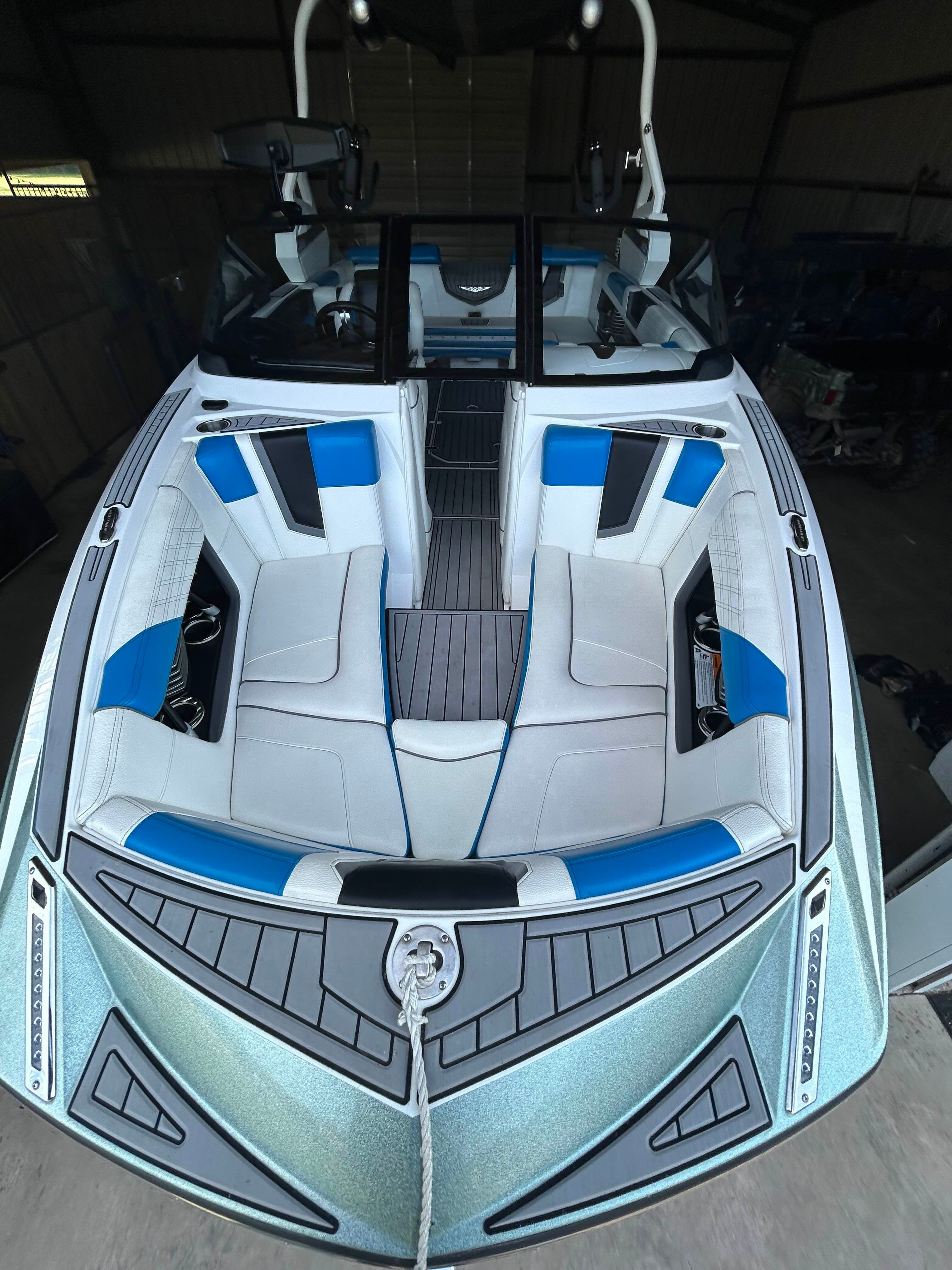 The image shows the interior of a 2019 Nautique G23 boat with blue and gray seating.