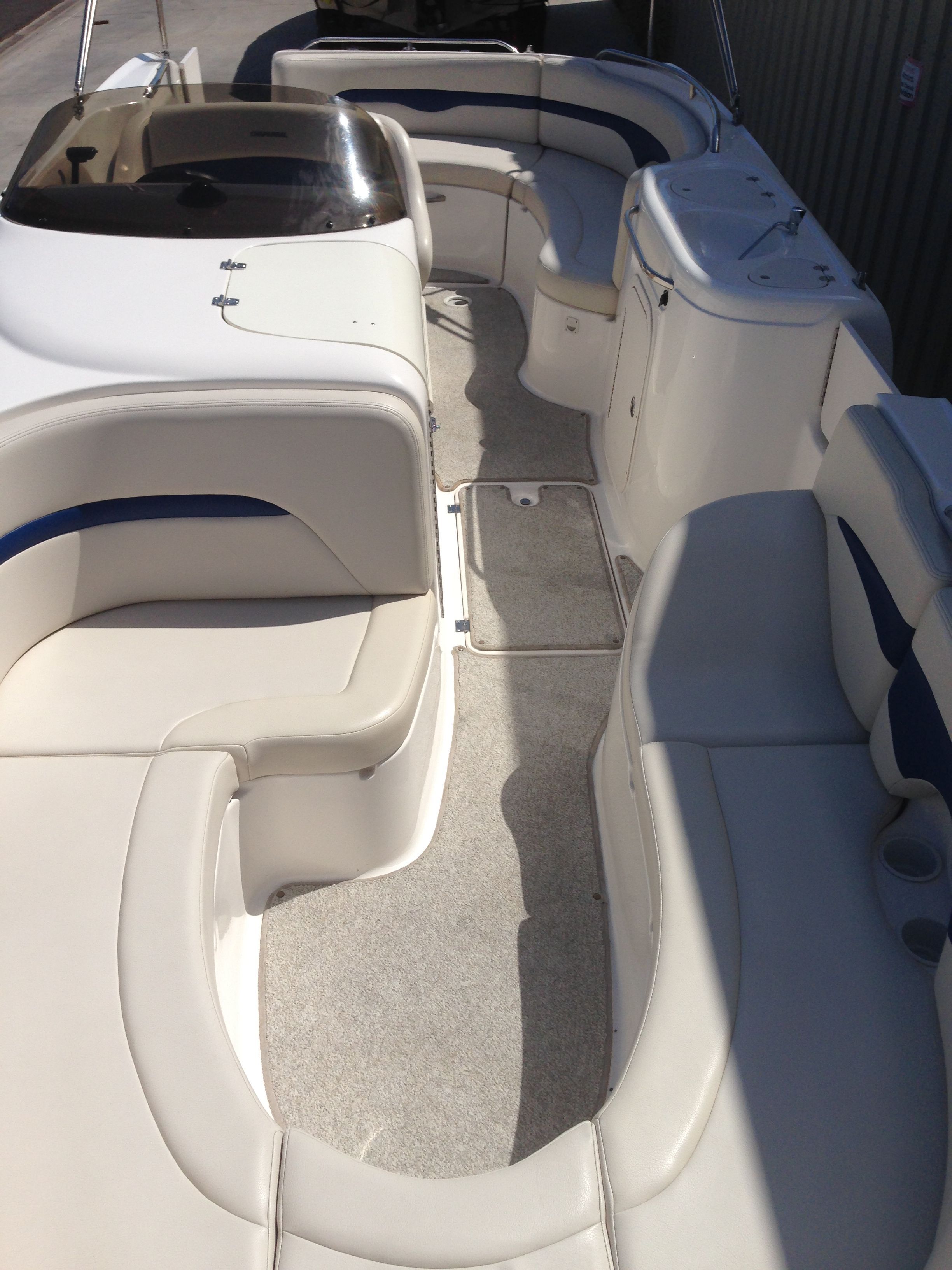 Interior of a 2003 Chaparral Sunesta 242 boat with seating area.
