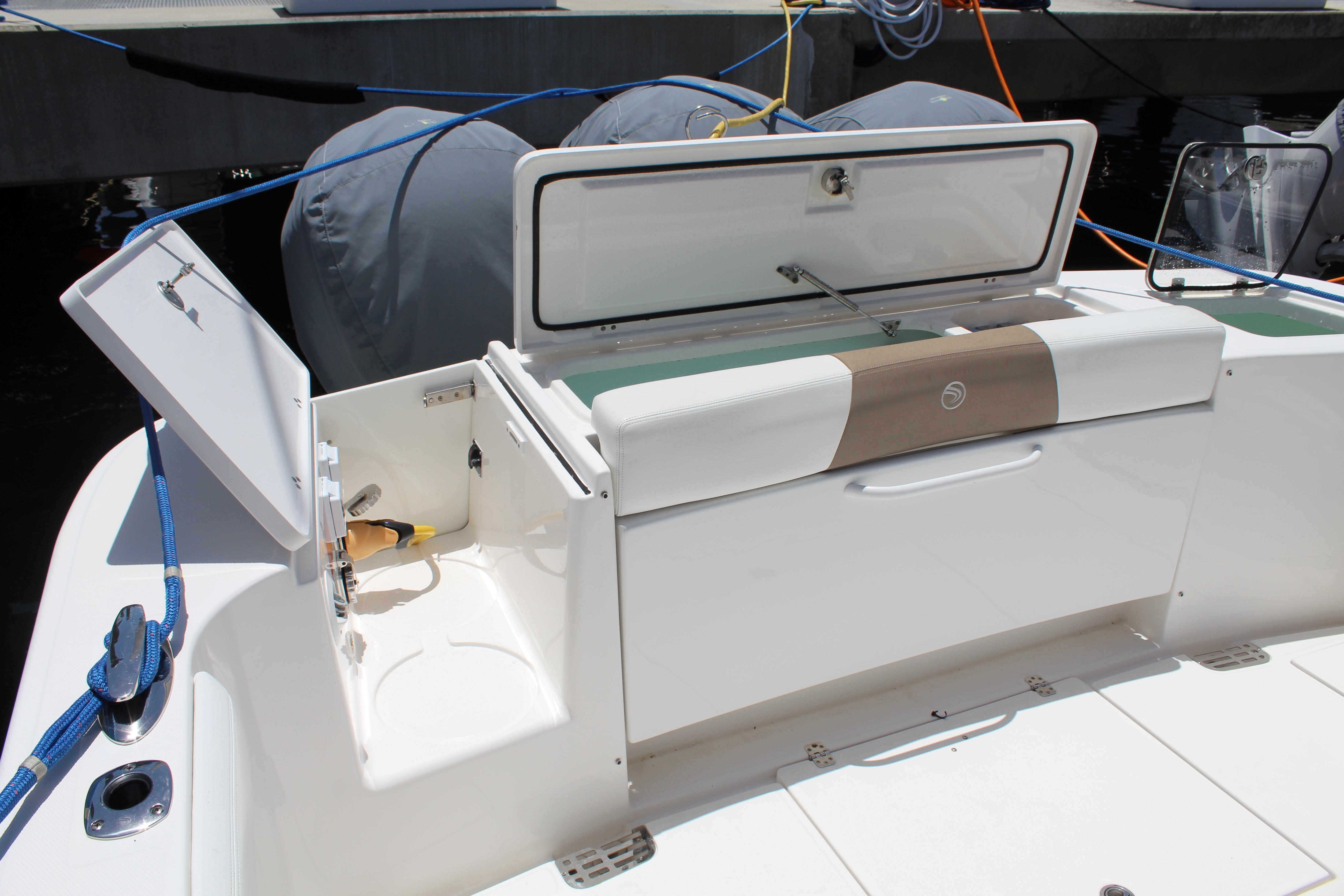 2016 Edgewater 370CC boat with open storage compartments and seating area.
