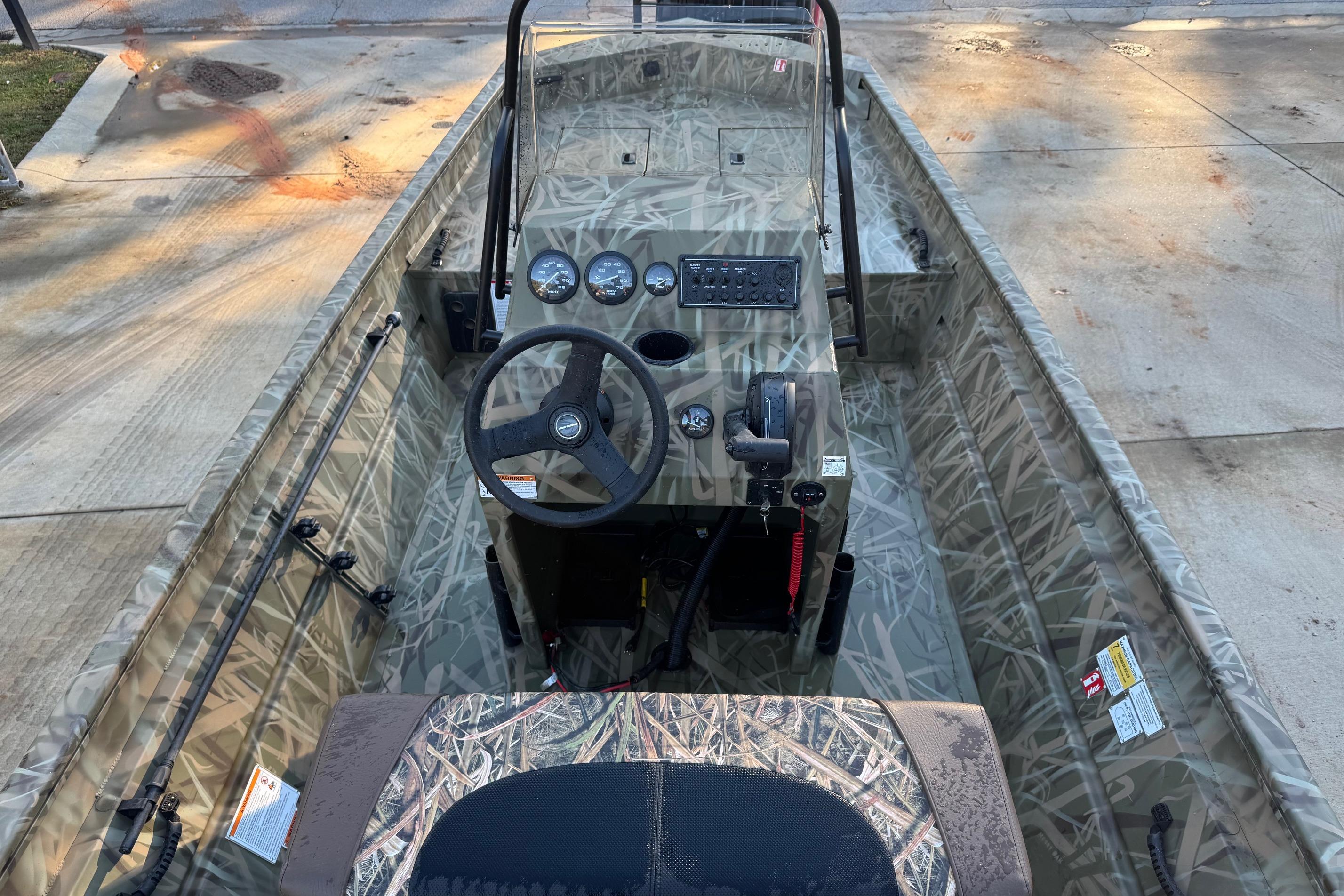 2026 Crestliner 1860 Retriever CC boat interior with camouflage design and control panel.