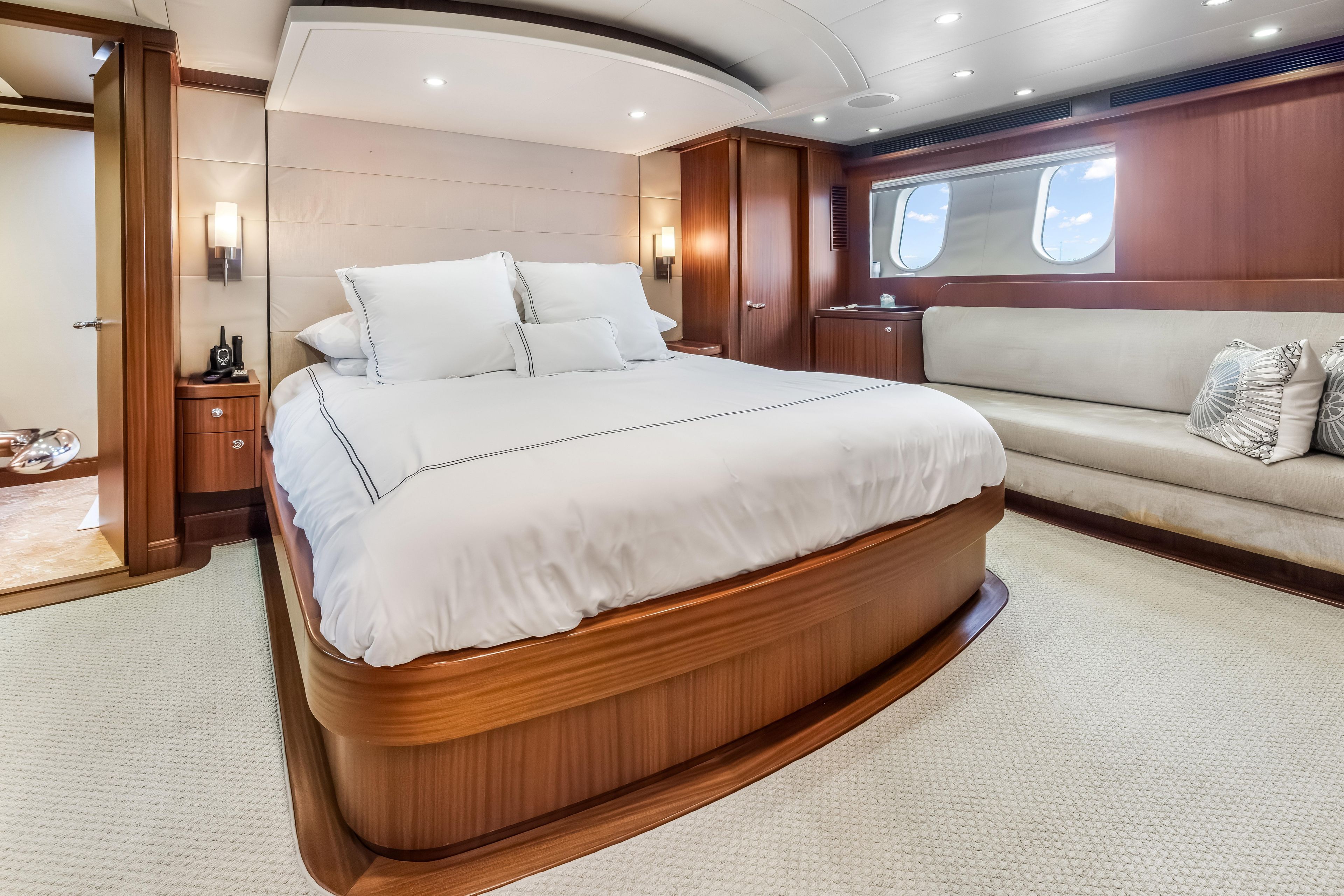 Luxurious bedroom interior of 2012 Cheoy Lee 84 Bravo yacht with elegant wood finishes.