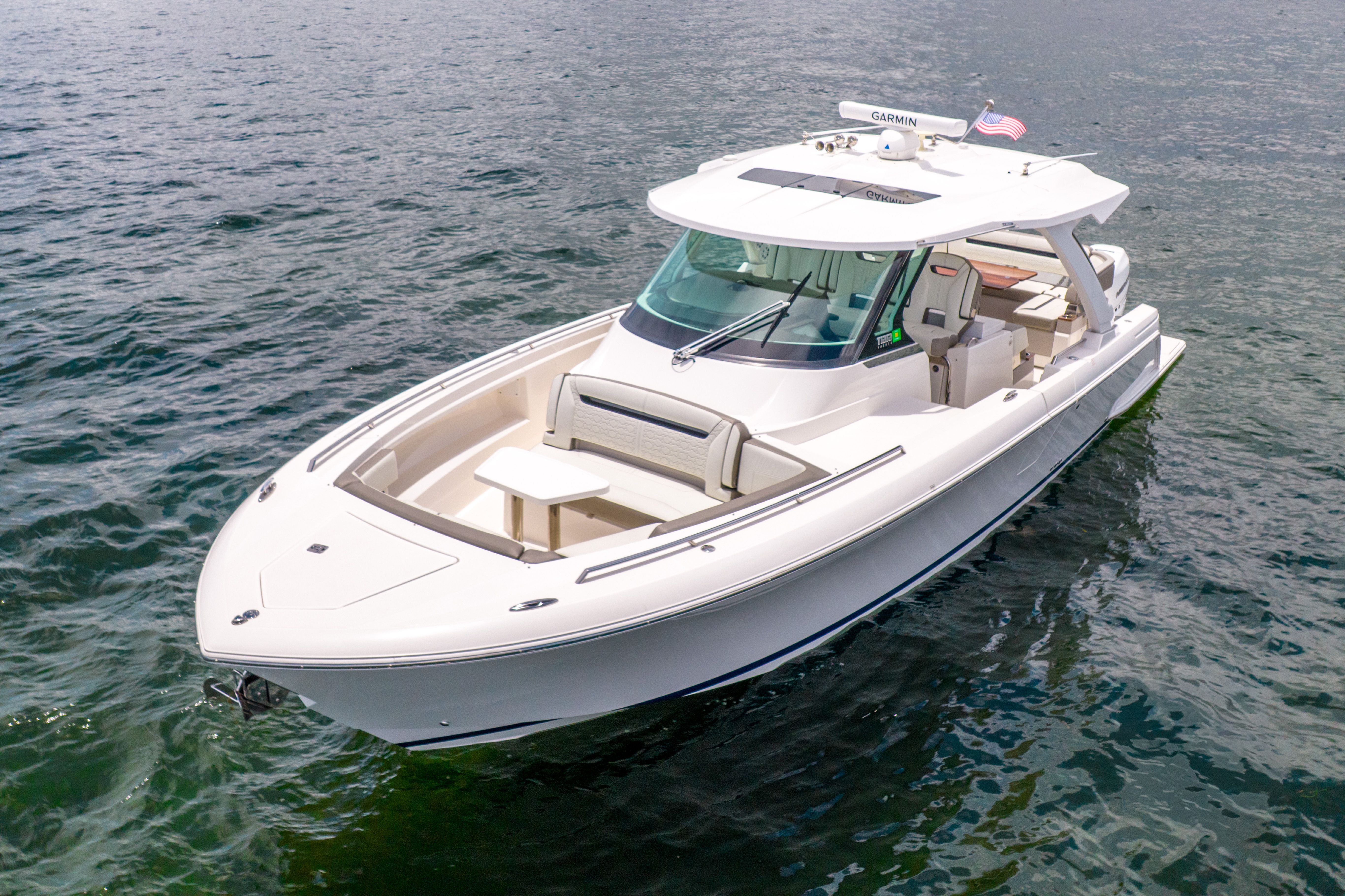 2023 Tiara Yachts 38 LS on calm water, featuring sleek design and spacious deck.