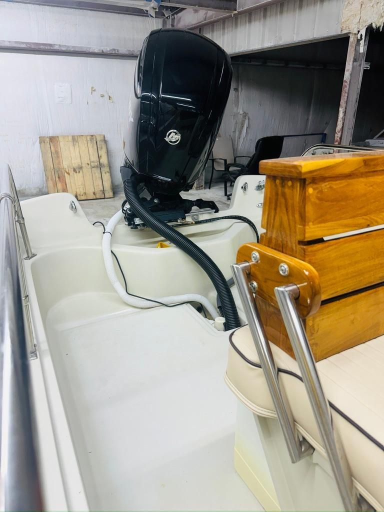A 1986 Boston Whaler 17 Montauk with an outboard motor and wooden interior elements.