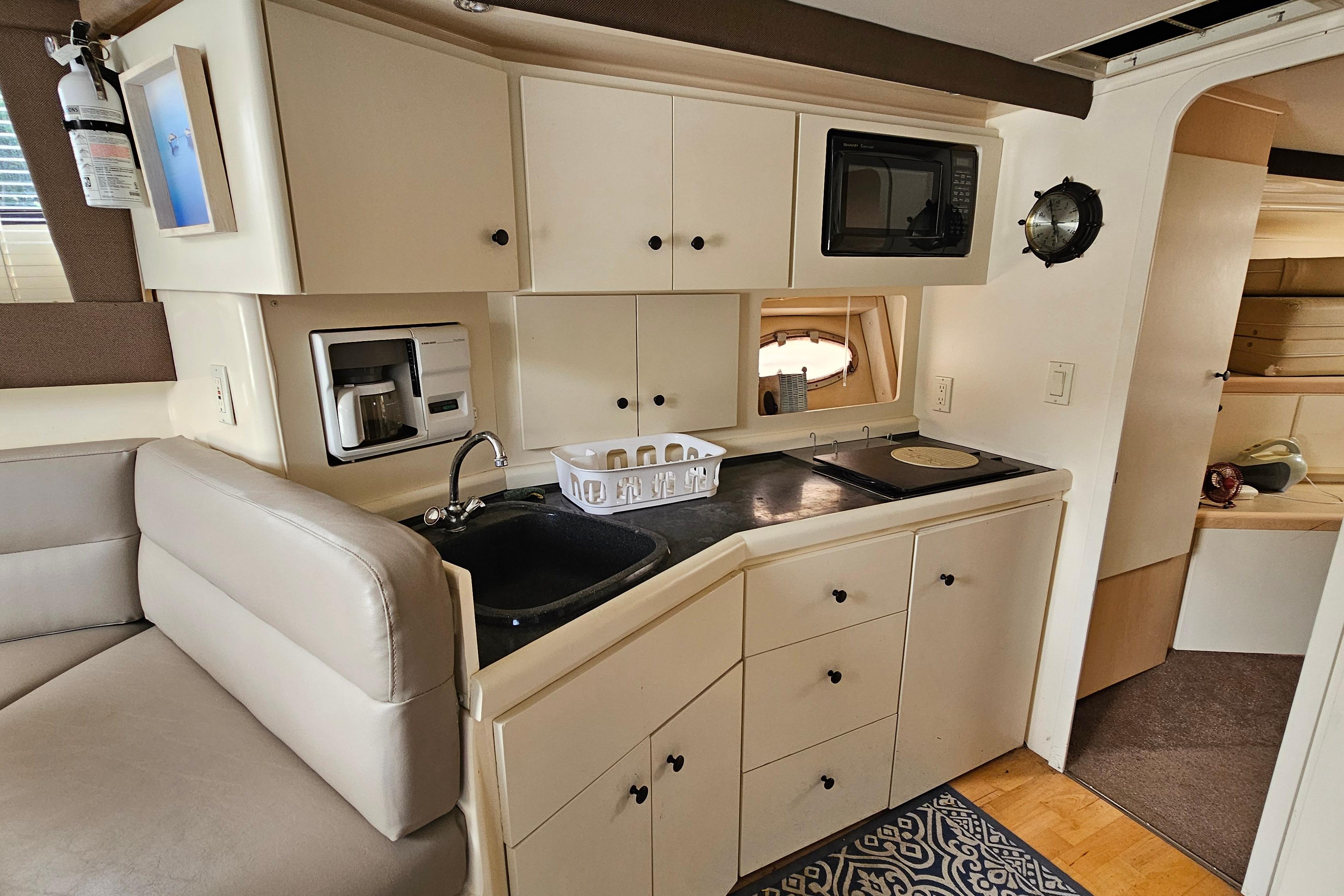 Interior of a 1999 Carver 350 Mariner yacht featuring a compact kitchen area.