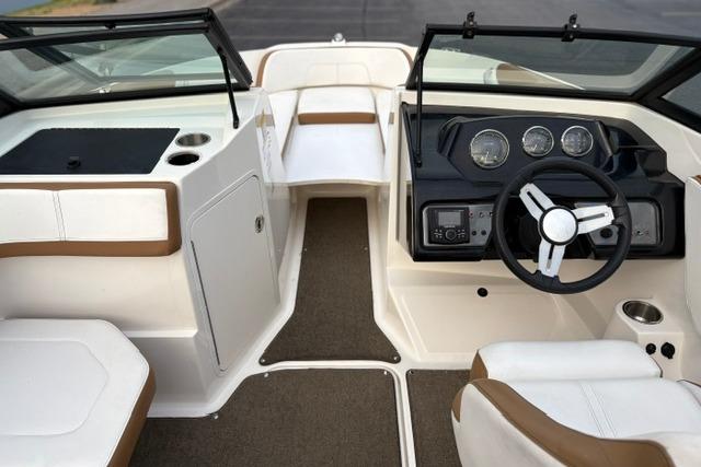 2017 Searay SPX210 boat interior with steering wheel and seating area.