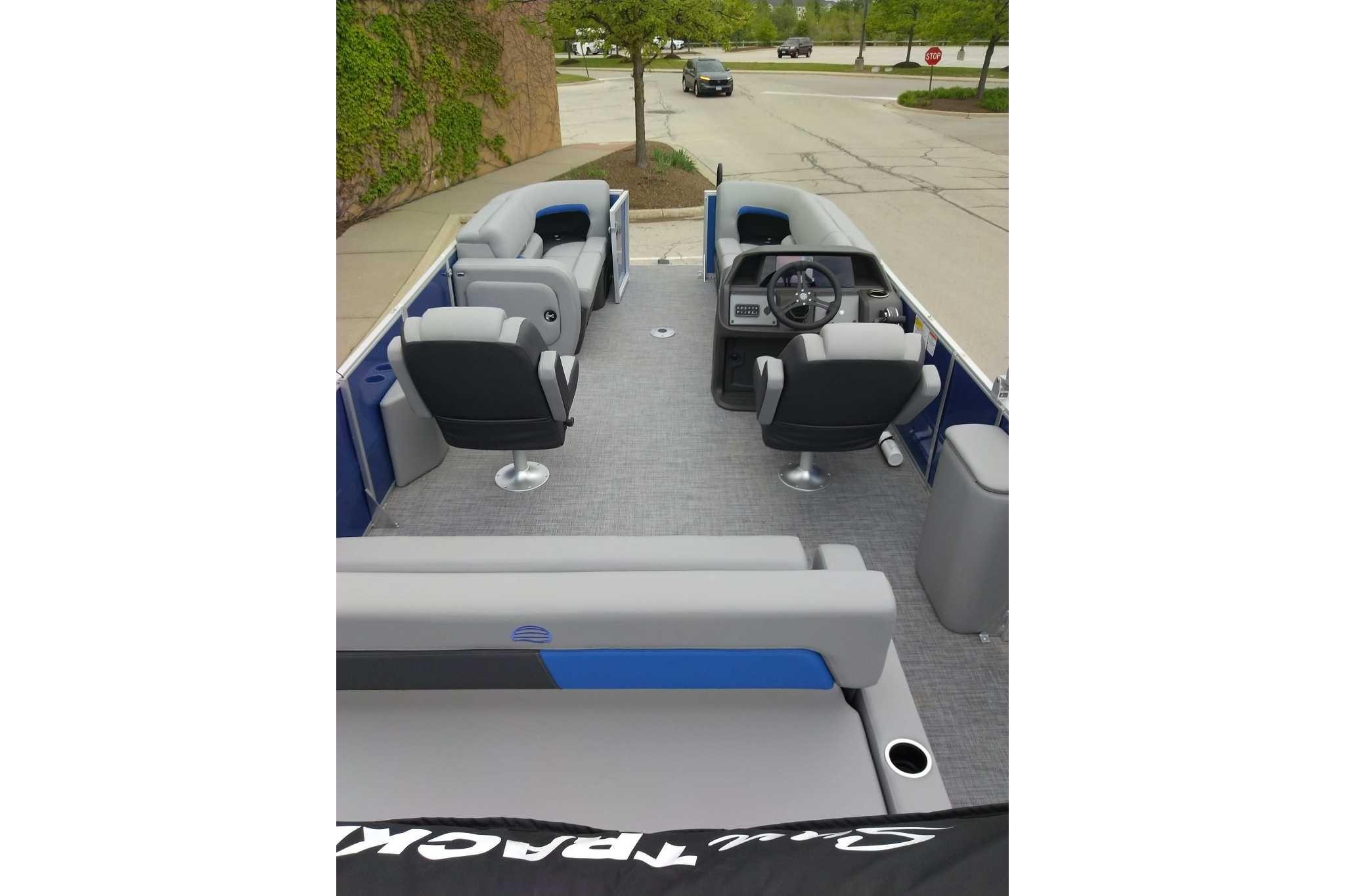 2026 Sun Tracker Party Barge 22 RF DLX interior with seating and steering console.