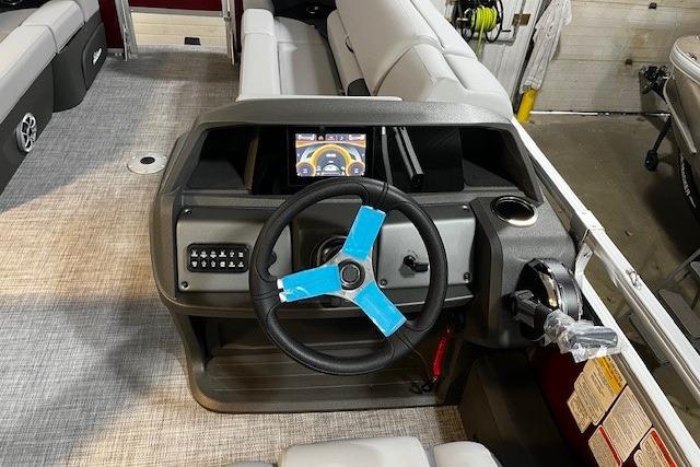 2026 Sun Tracker SportFish 22 DLX boat dashboard with steering wheel and control panel.