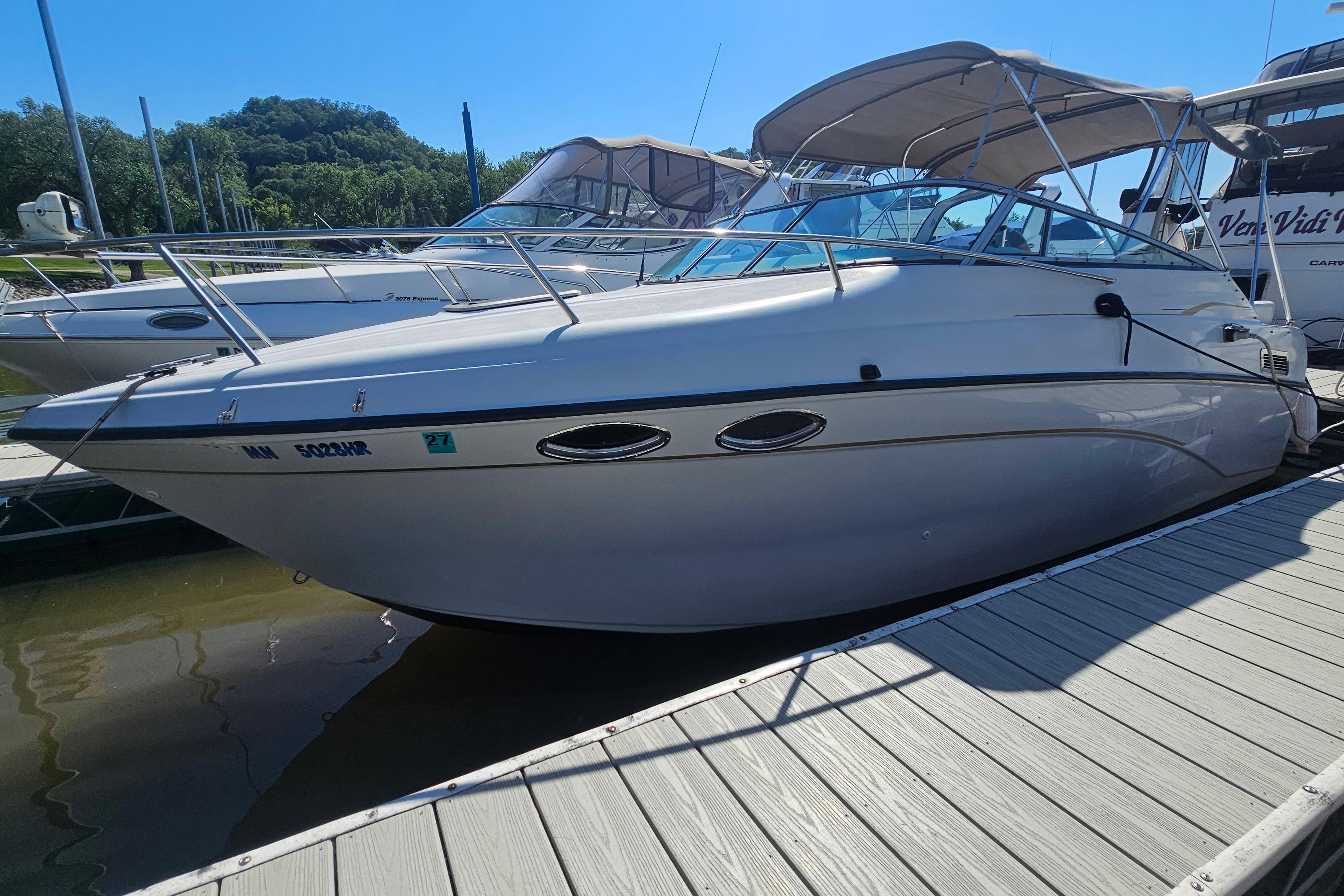 2000 Crownline 242 CR boat docked at marina under clear blue sky.