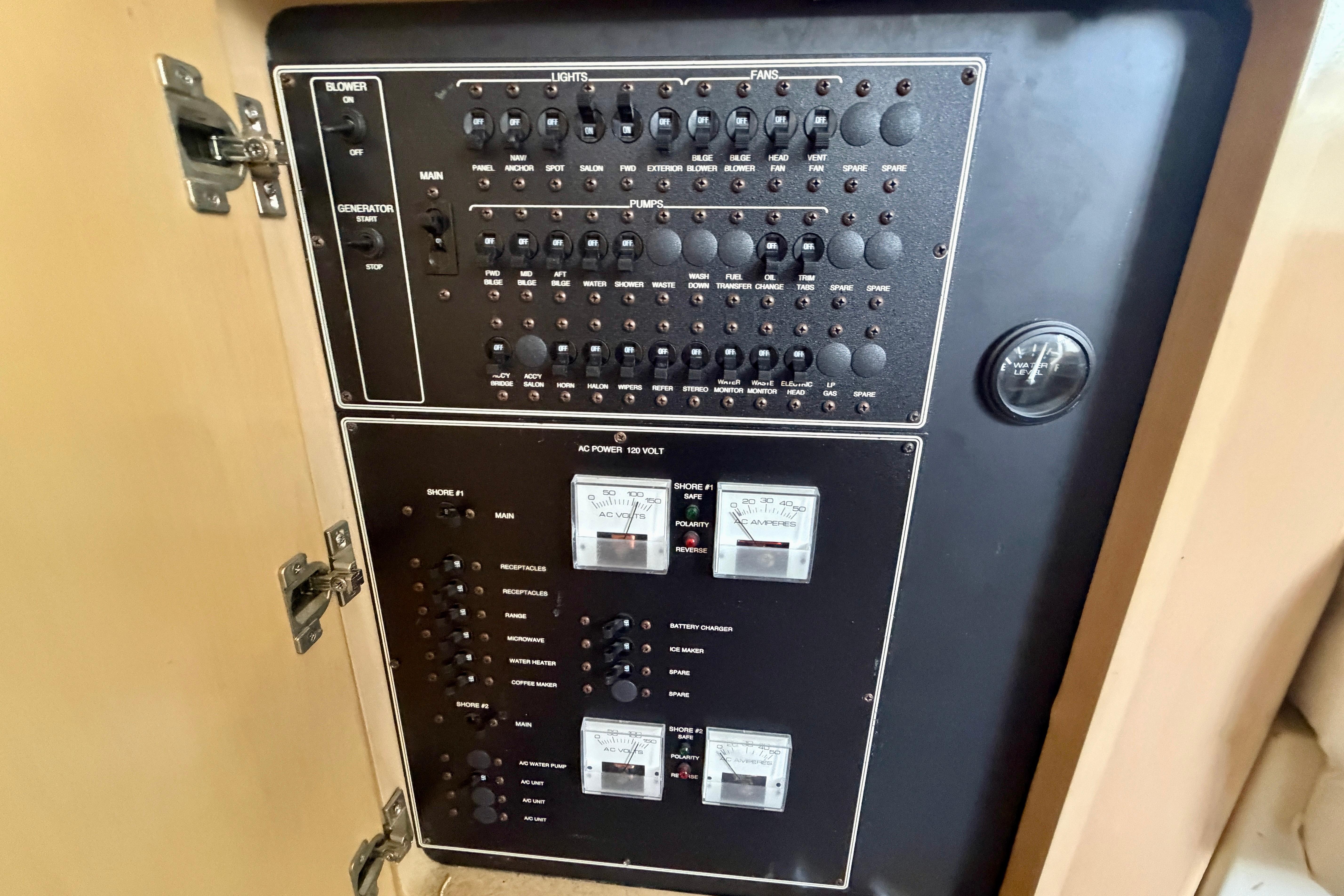Electrical control panel on a 2000 Carver 350 Mariner boat, featuring switches and gauges.