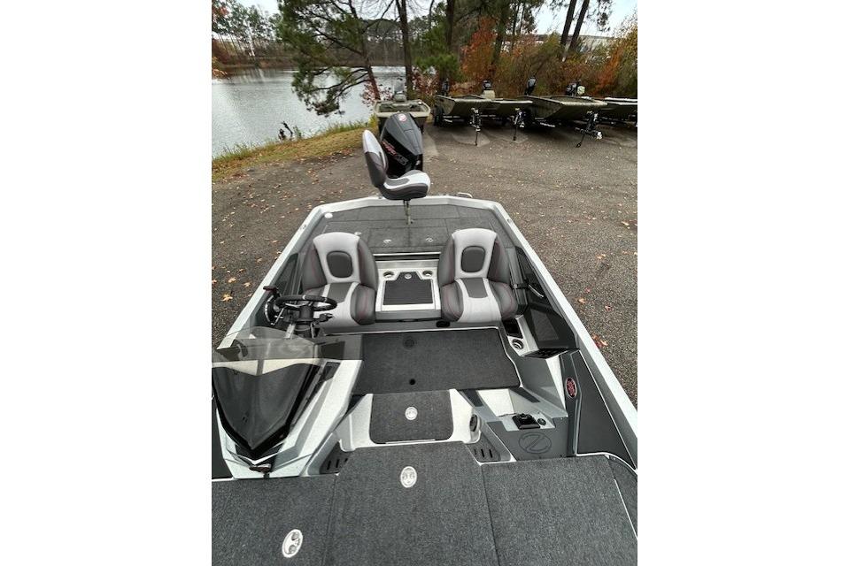 2024 Ranger Z519 Ranger Cup Equipped boat with dual seats, parked near a lake.
